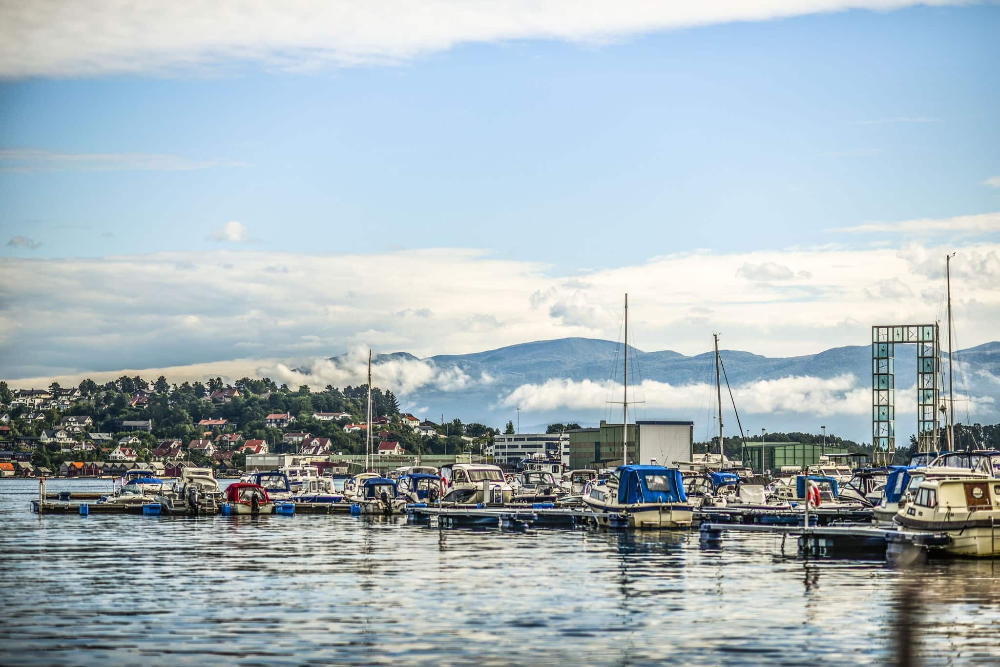 View of the marina in the town of Leirvik, Norway, in the background overcast sky over the fjords.
