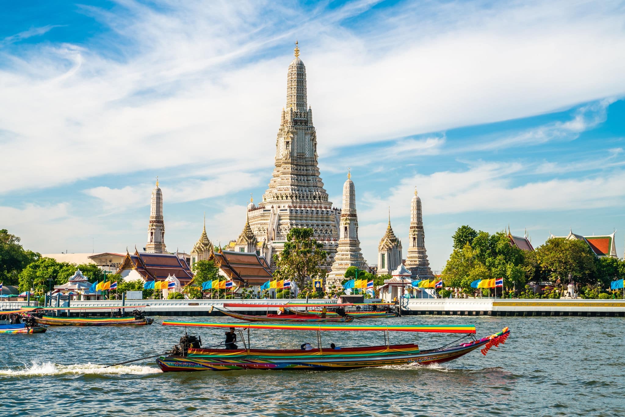 Temple of dawn Wat Arun with boat blue sky sunny day travelin Bangkok Thailand