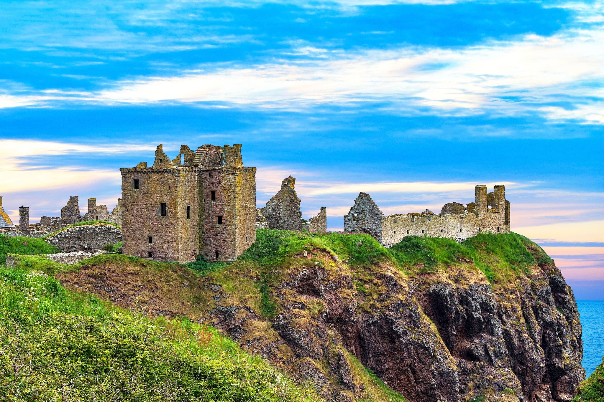 Dunnottar Castle  is a ruined medieval fortress located upon a rocky headland on the north-eastern. The Castle is open to the public all year.