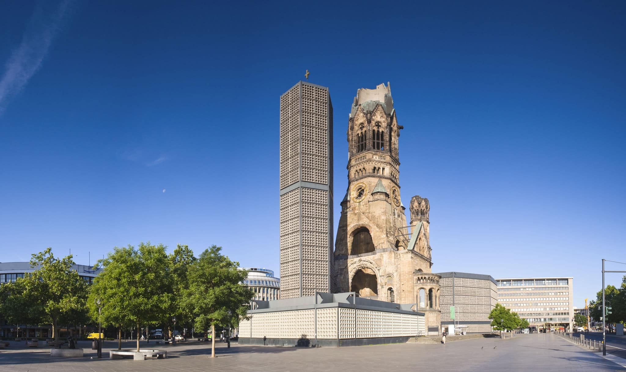 Kaiser-Wilhelm-Kirche, broken spire and modern bell tower overlook the busy Breitscheidplatz as symbols of the city's regeneration.