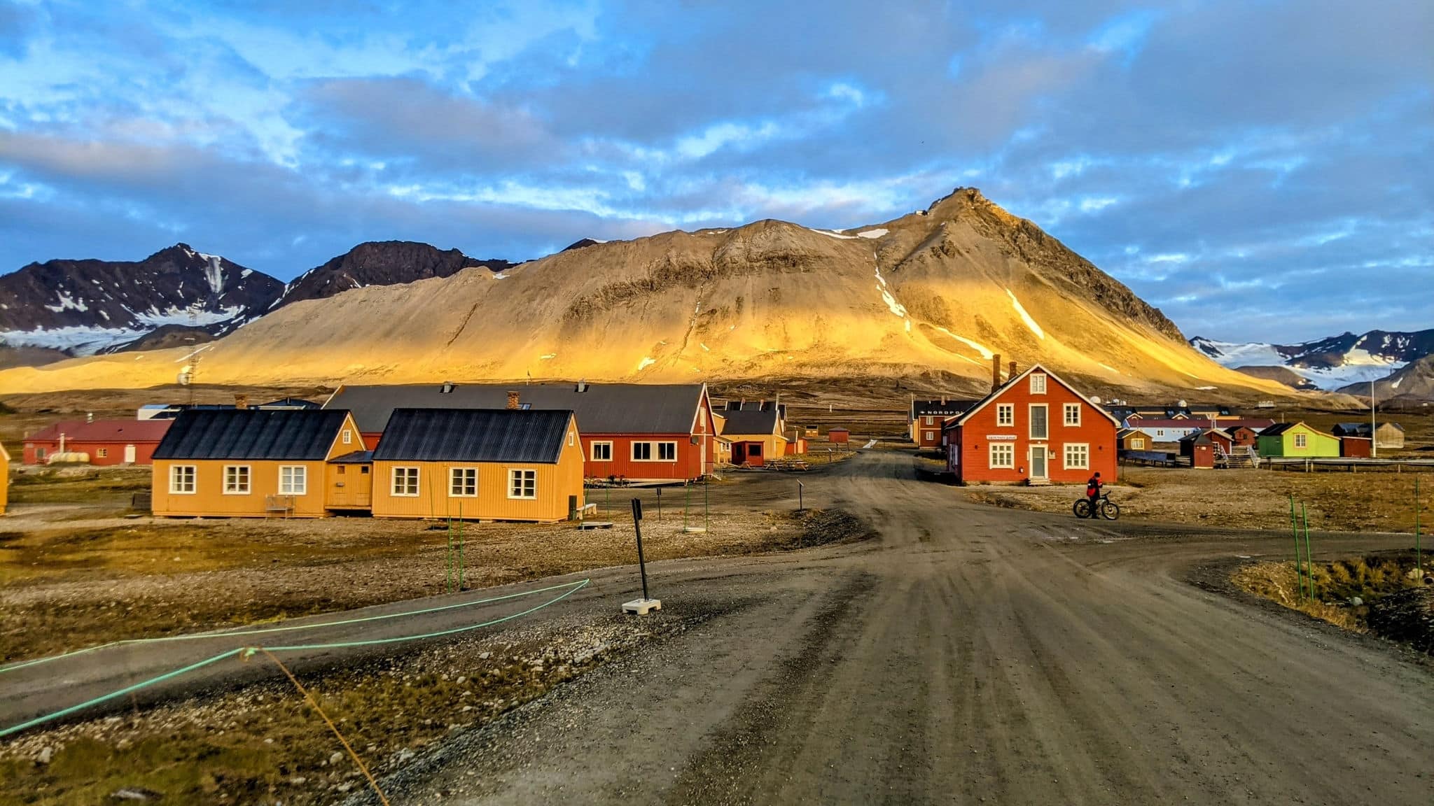 "Northernmost village, summer's midnight sun, and a breathtaking view combine in this captivating image. Nature's beauty at its peak."