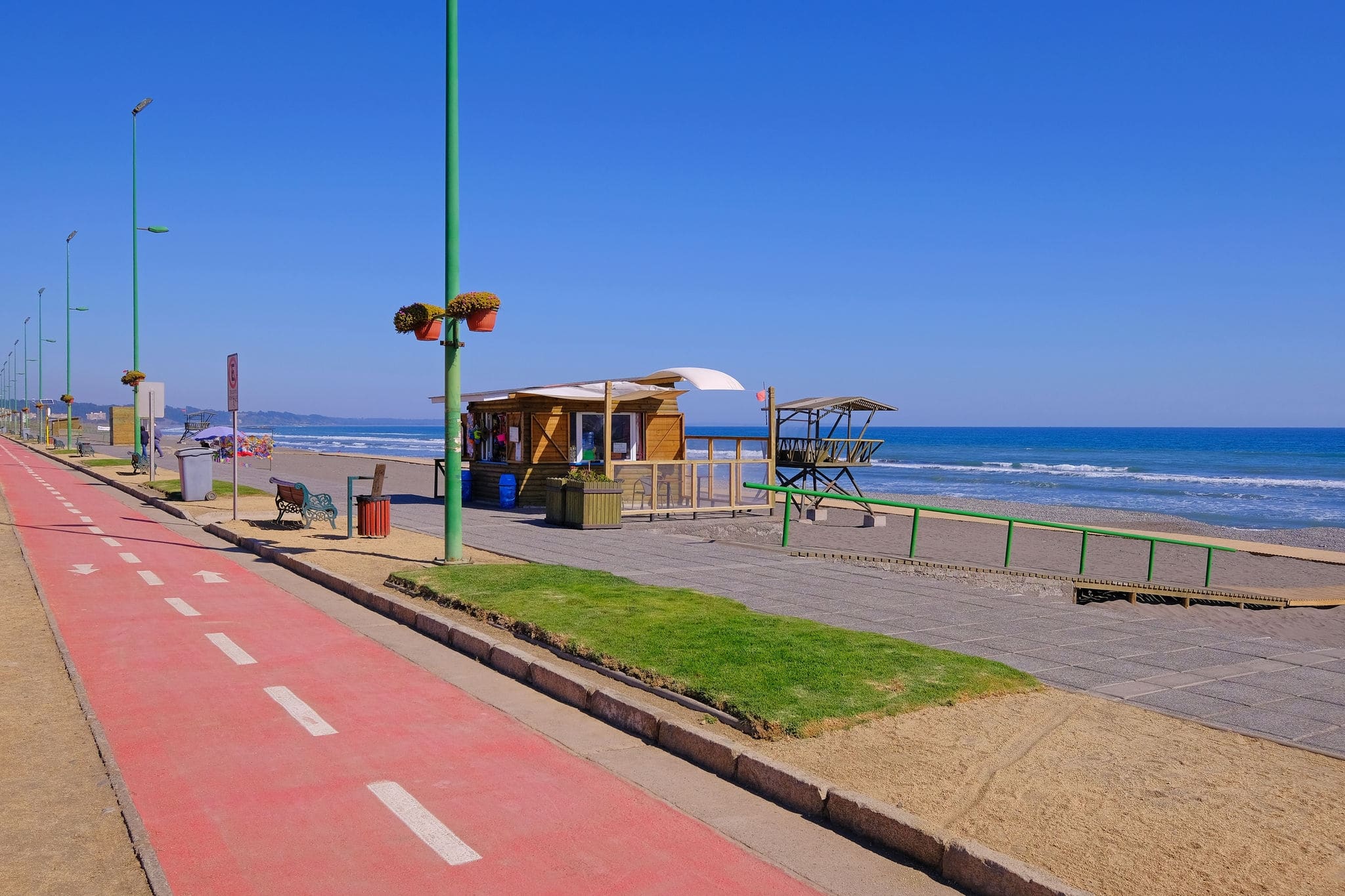 Coastal Pacific beach promenade with paved bike path and sandy beach, San Antonio, Valparaiso region, Chile, South America