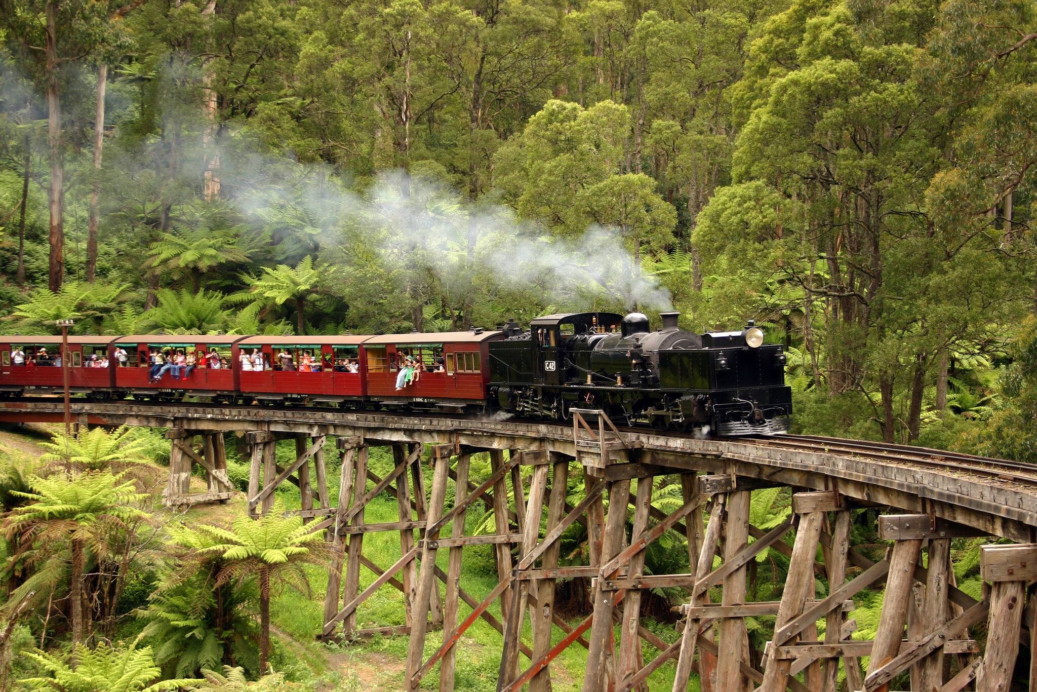 Old steam train crossing a bridge