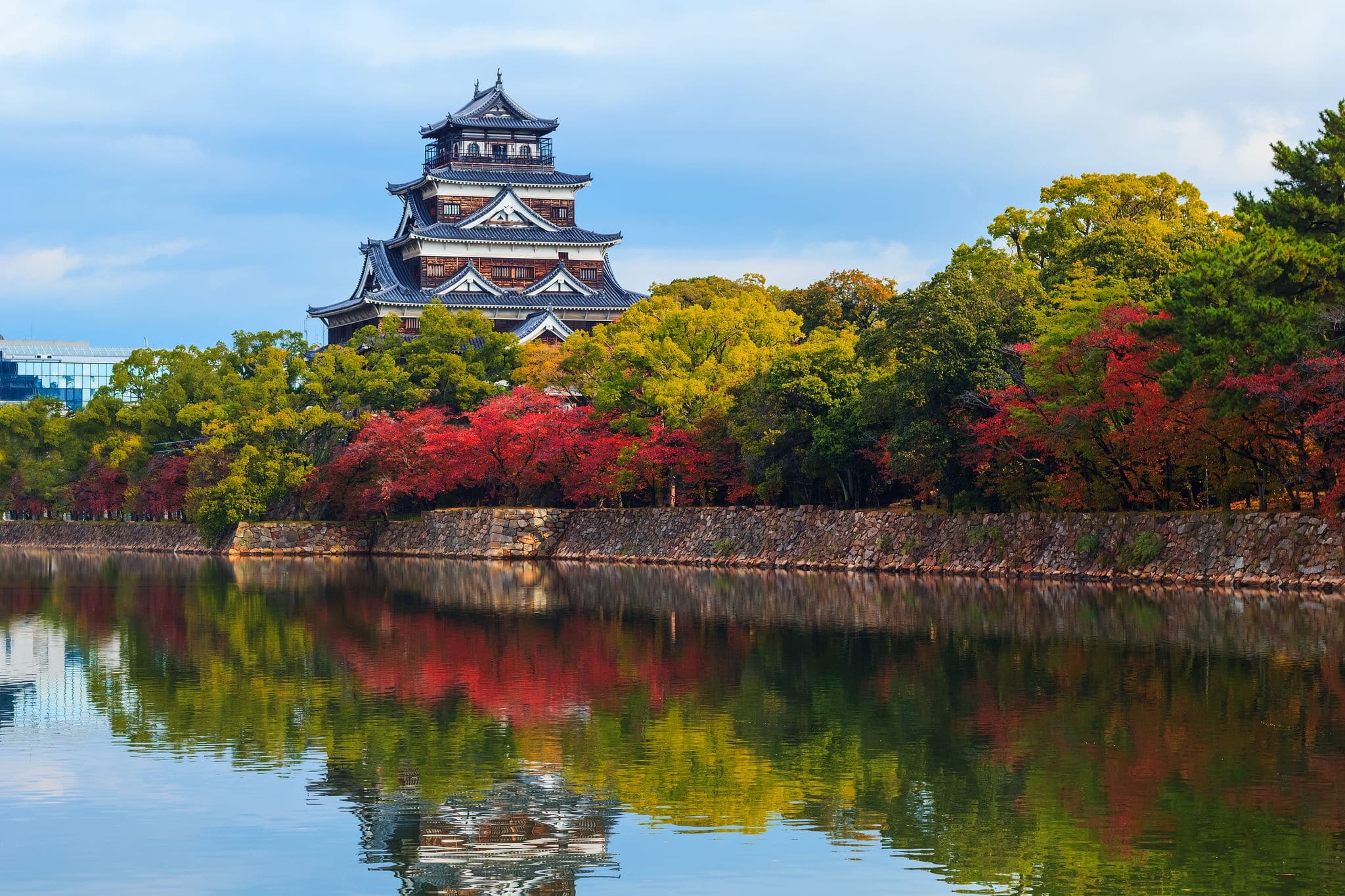 Hiroshima castle on the side of Otagawa river in autumn 