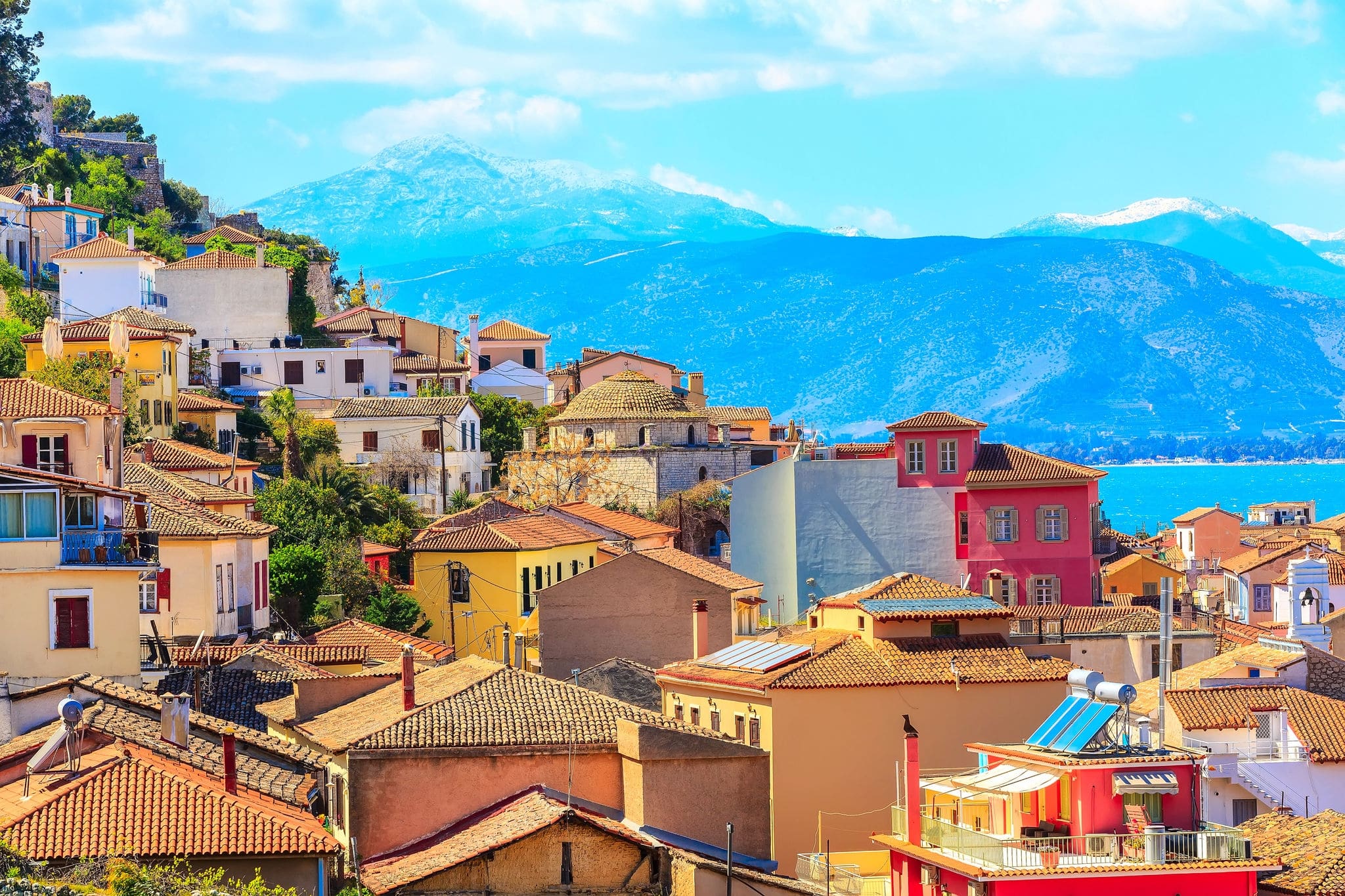 Nafplio or Nafplion, Greece, Peloponnese old town houses aerial panorama with sea and snow mountain peaks