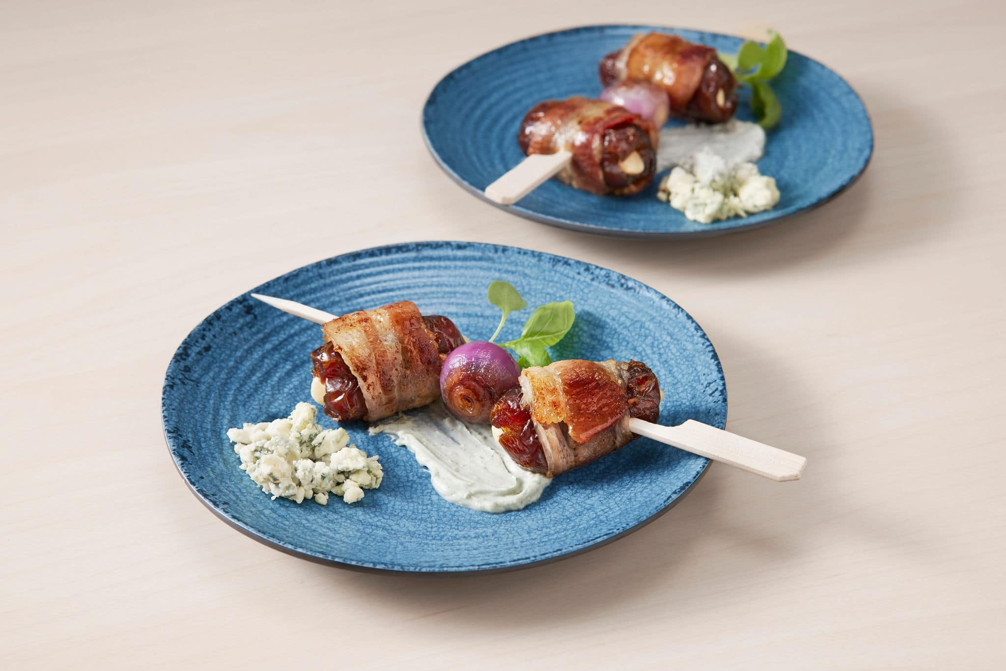 Appetizers on blue plates. 