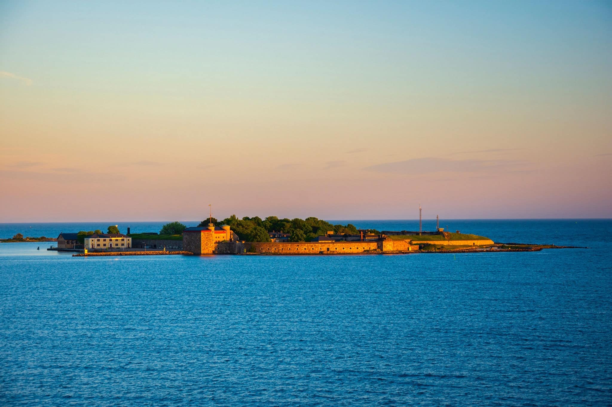 Magnificent sunset view on the island with Kungsholms Fort (coastal artillery fortress for control of Karlskrona harbour). Location place: the Baltic Sea near Karlskrona, Sweden.