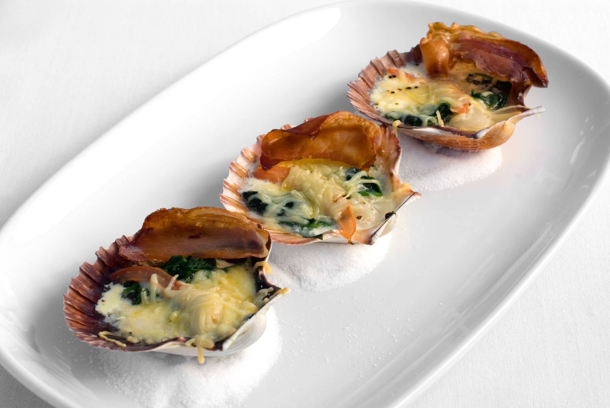 Tasmanian Scallops in the shell, grilled with Pancetta, Spinach, and a two-cheese sauce