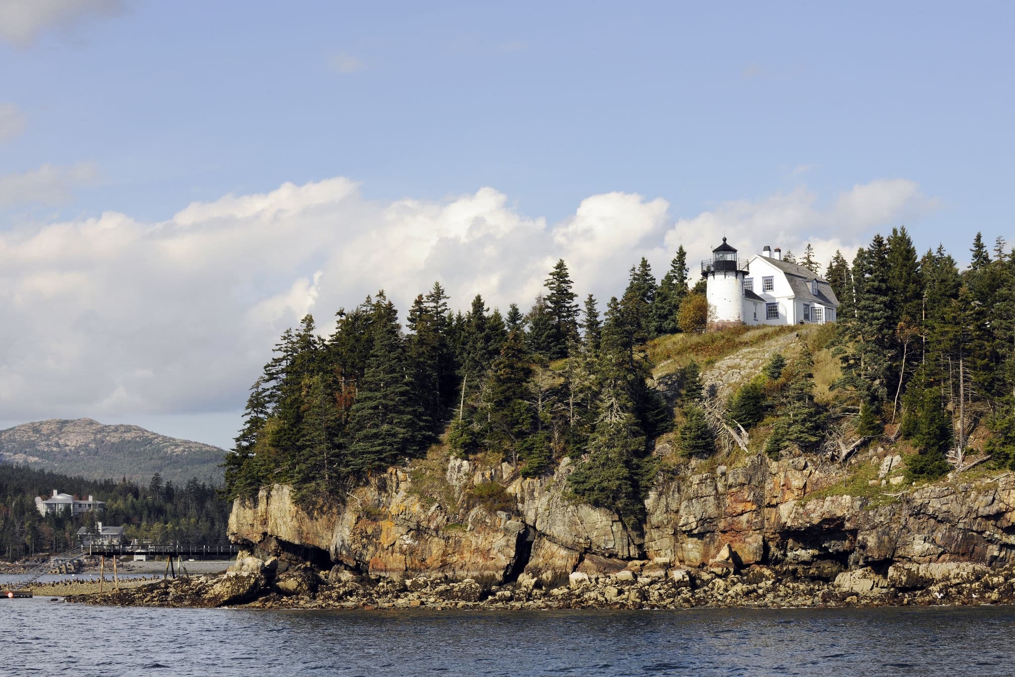 A scenic view of a Bar Harbor, Maine lighthouse on a beautiful autumn day. Taken from the water.  Focus on the lighthouse.