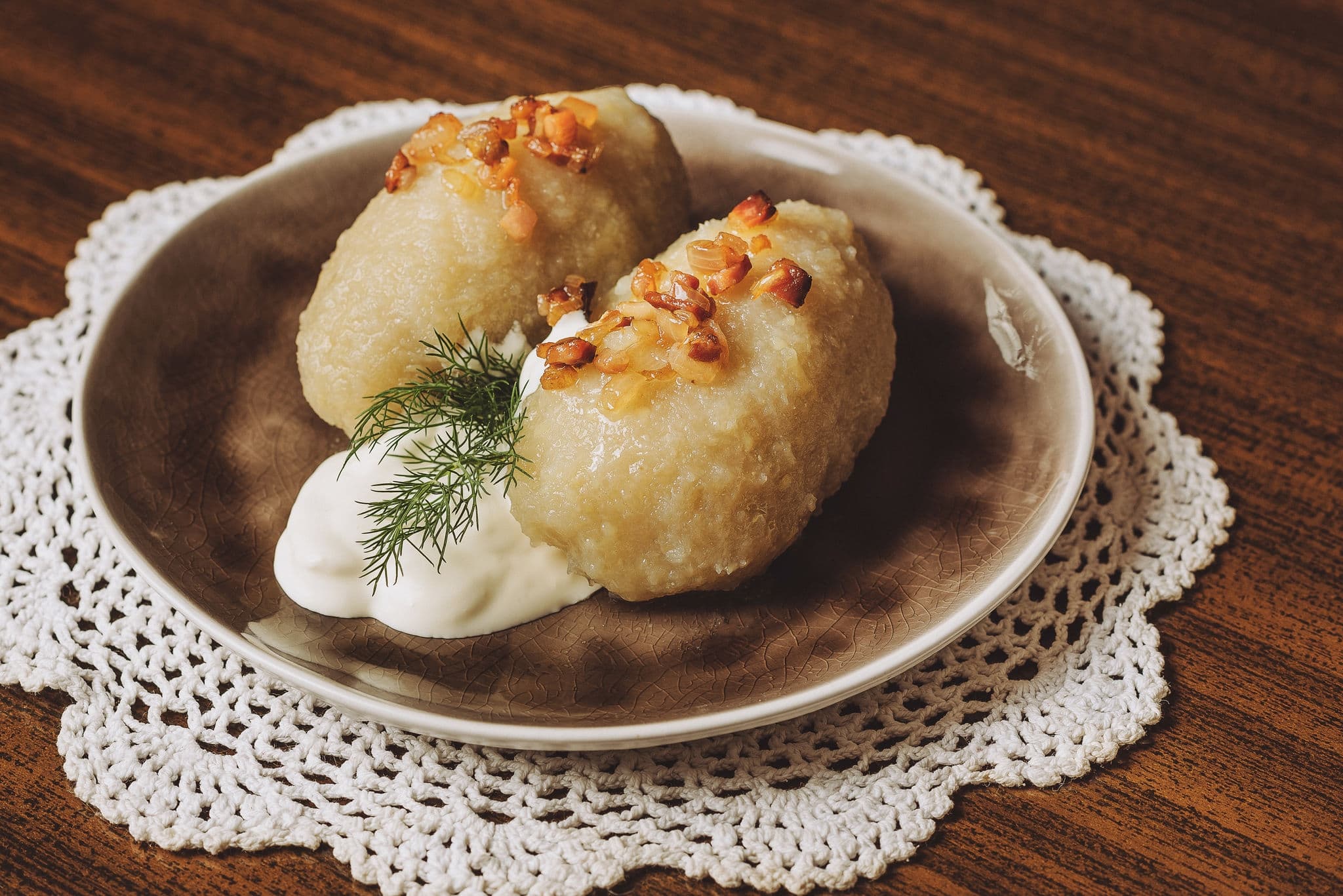 Traditional Lithuanian dish of stuffed potato dumplings (cepelinai). The dumplings are made from grated and riced potatoes and stuffed with ground meat or dry curd cheese or mushrooms