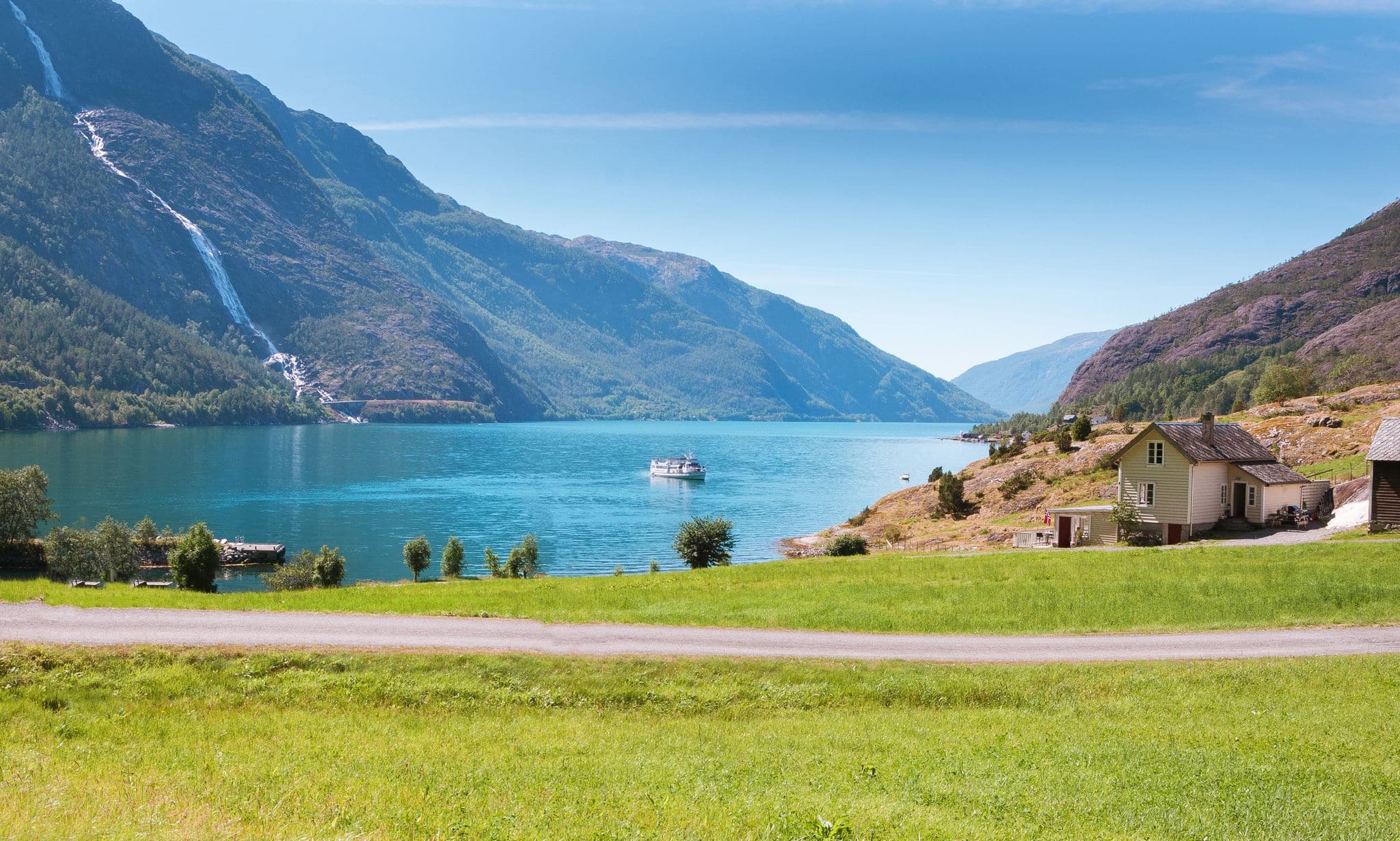 Image of boat, waterfall and beautiful colors of nature in the amazing Akrafjorden. Norway