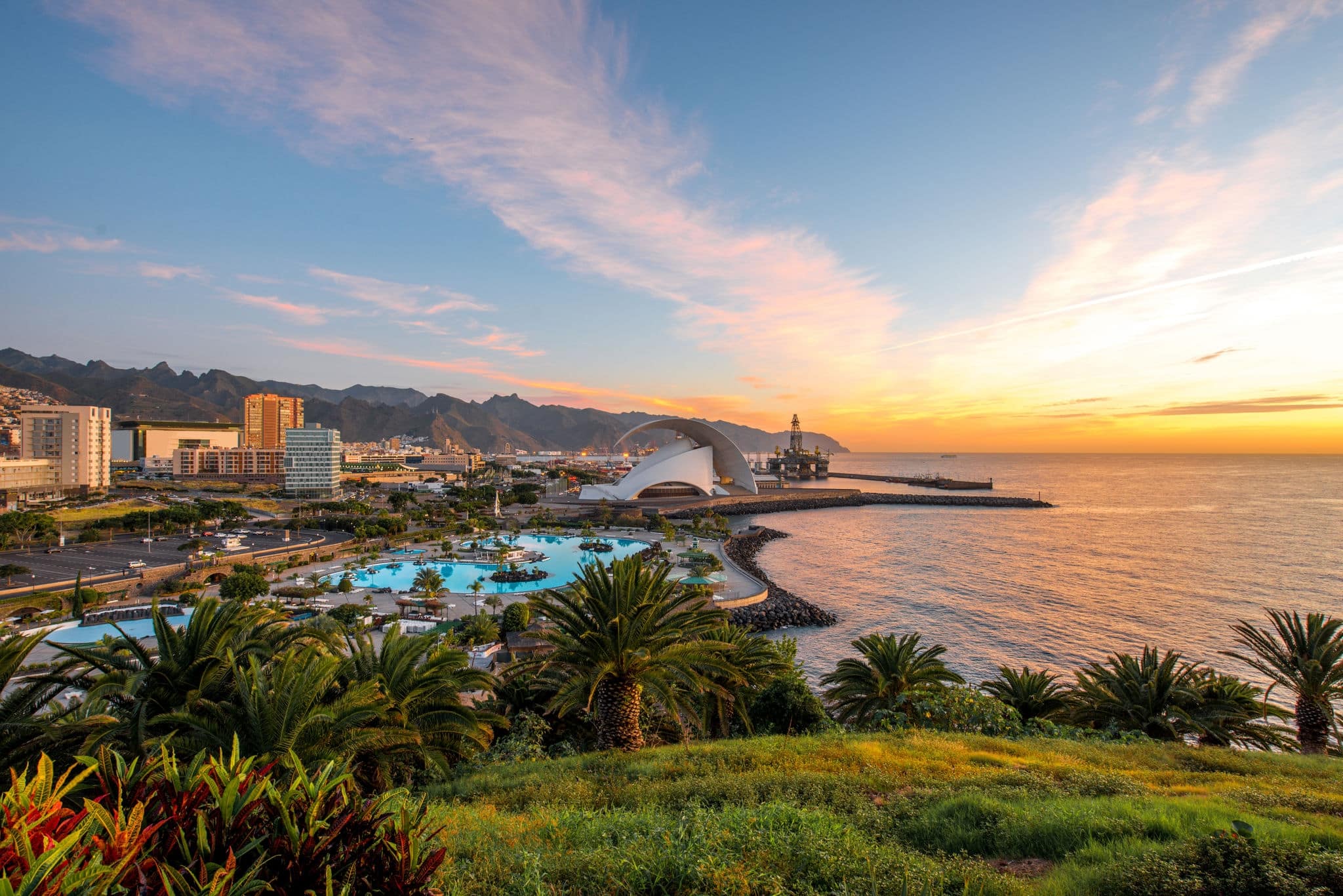 Santa Cruz cityscape view with park, ocean and mountains on the background on the sunrise, Canary islands, Spain  