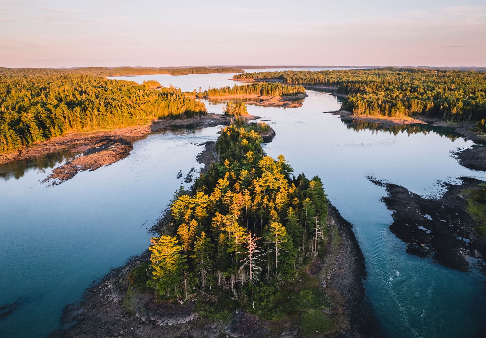 Aerial image of rocky shoreline of Cobscook Bay, Maine at sunset in Lubec, Maine, United States
