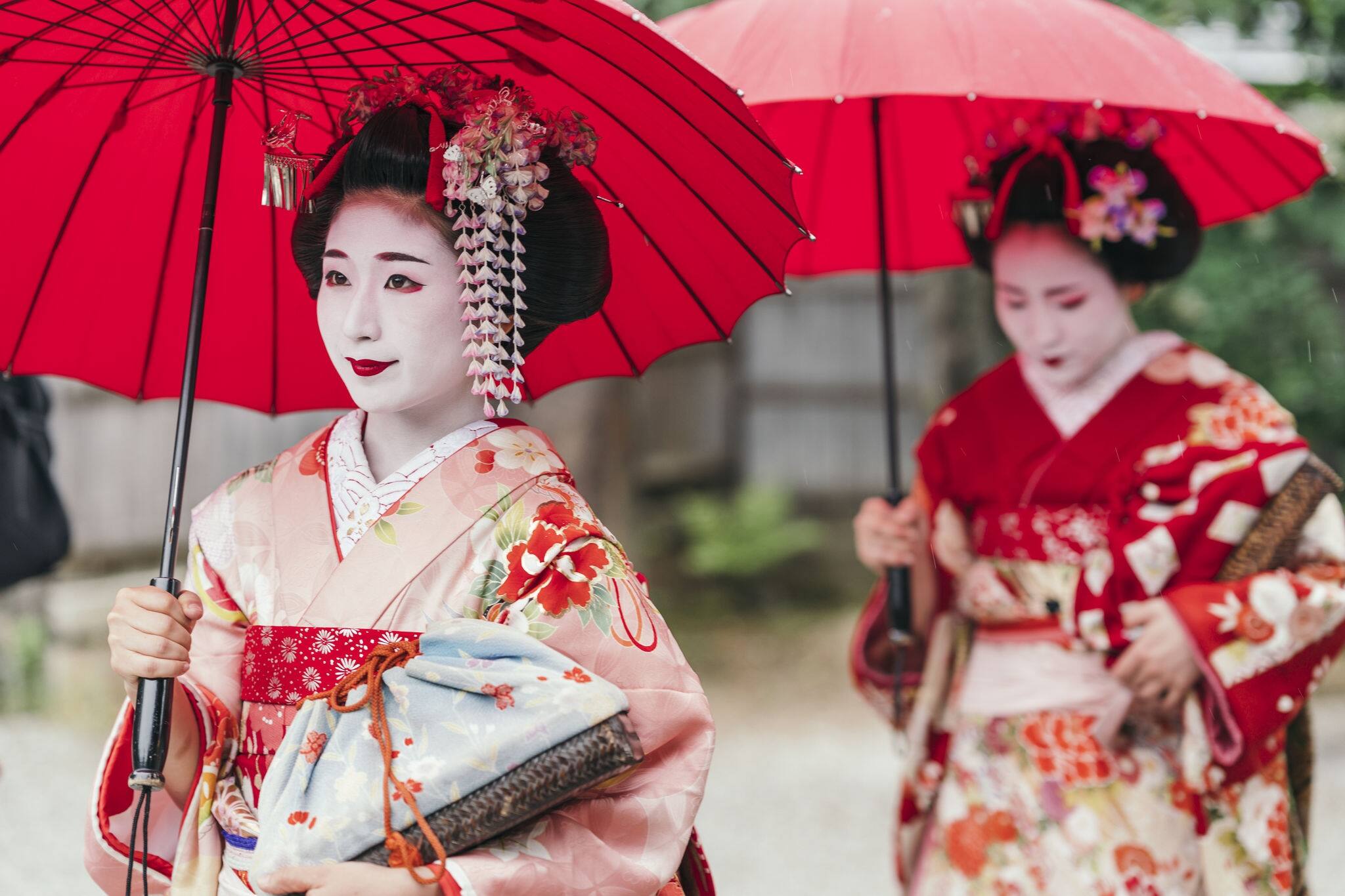 Maiko geisha walking on a street of Gion in Kyoto Japan