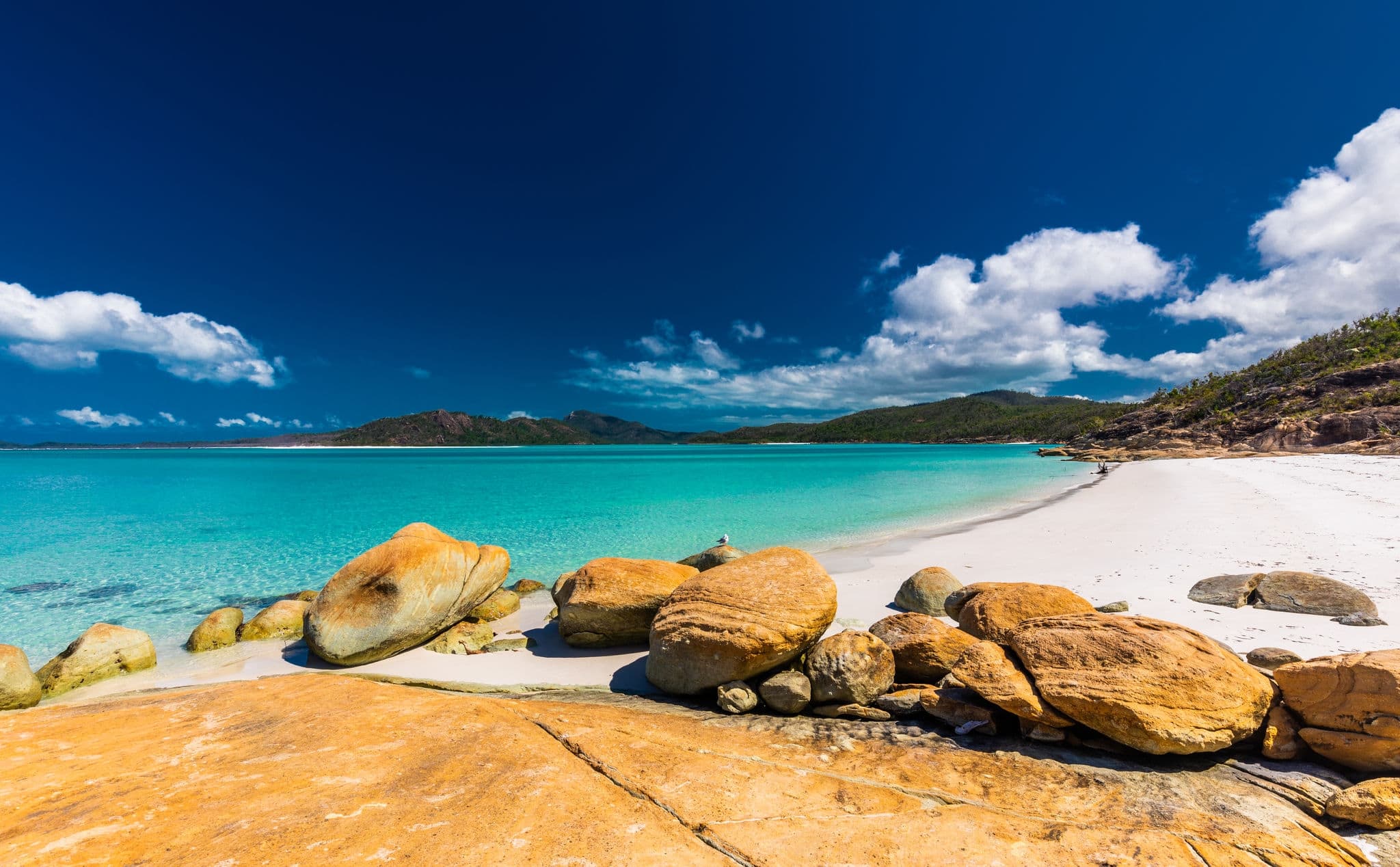 Rocks on the amazing Whitehaven Beach with white sand in the Whitsunday Islands, Queensland, Australia