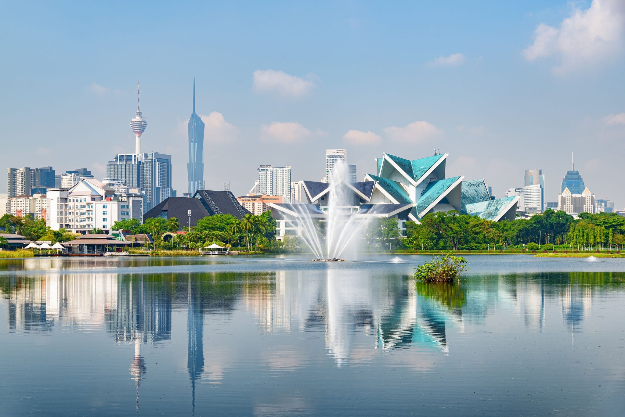 Awesome Kuala Lumpur skyline. Amazing view of scenic lake and fountains in a city park of Kuala Lumpur, Malaysia. Beautiful cityscape. Kuala Lumpur is a popular tourist destination of Asia.