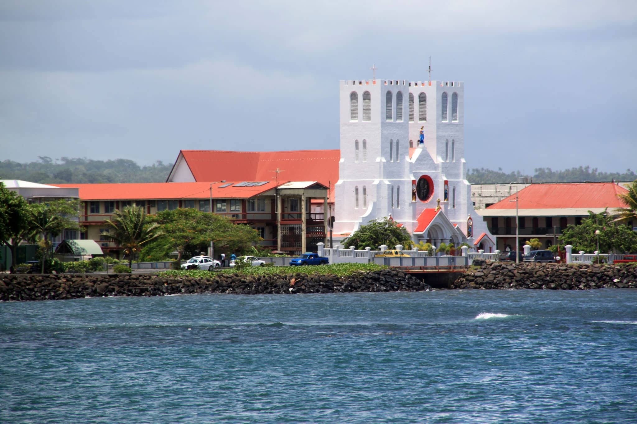 Blue waters in bay and white church in Apia, Samoa