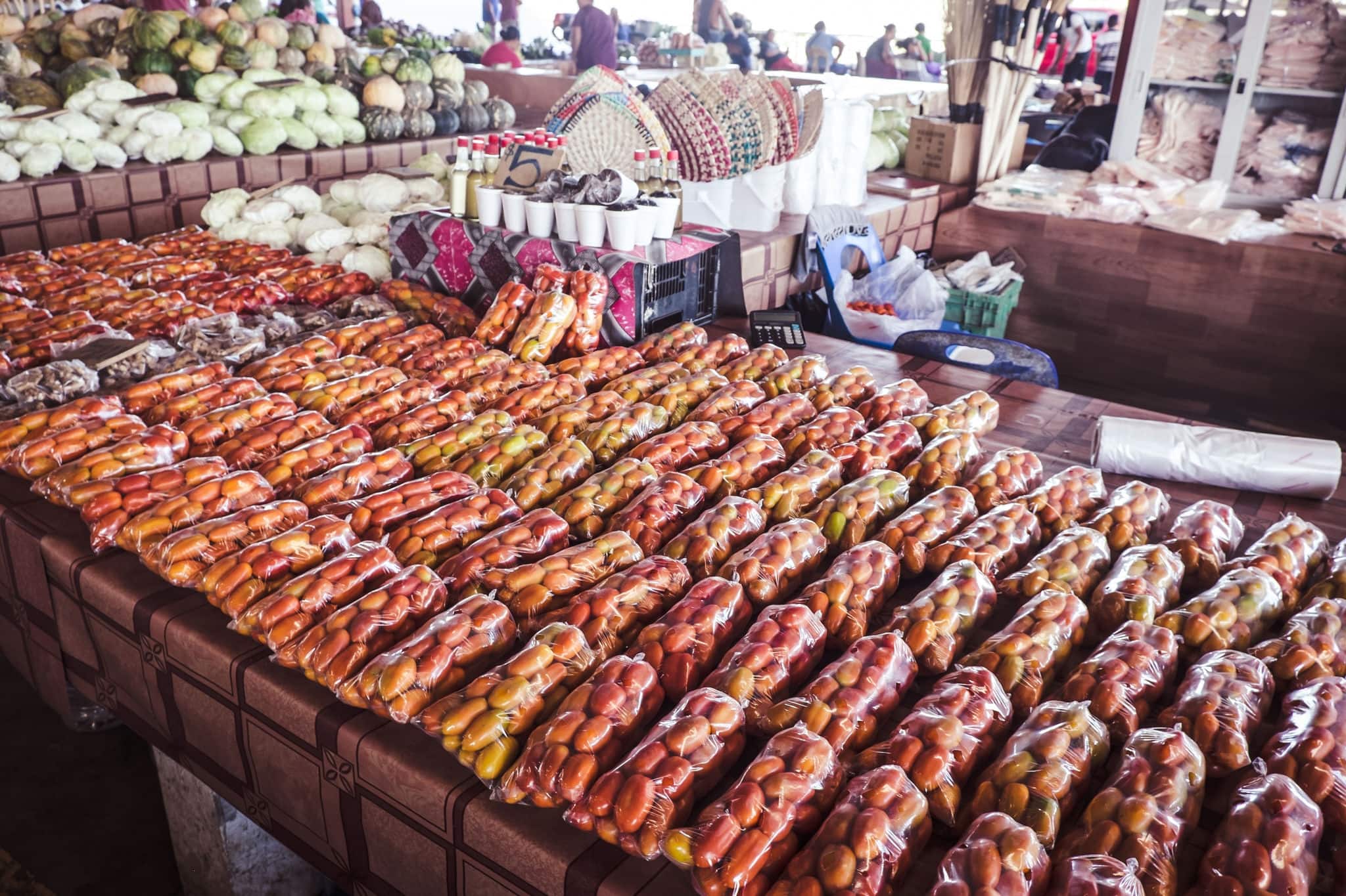 Tomatoes in plastic bags on display at Fugalei fresh produce market, Apia, Samoa