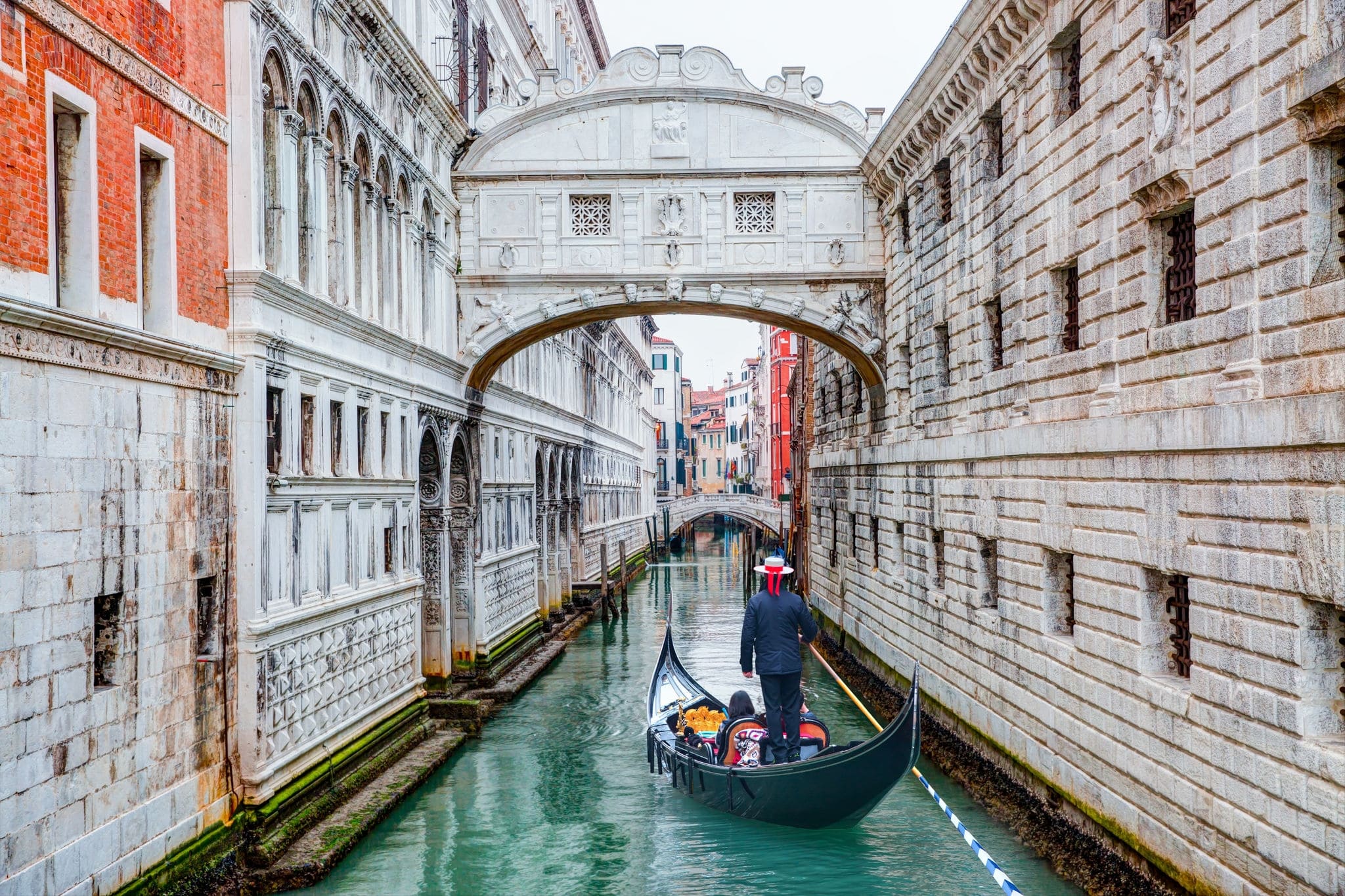 Gondolas floating on canal towards Bridge of Sighs (Ponte dei Sospiri). Venice, Italy