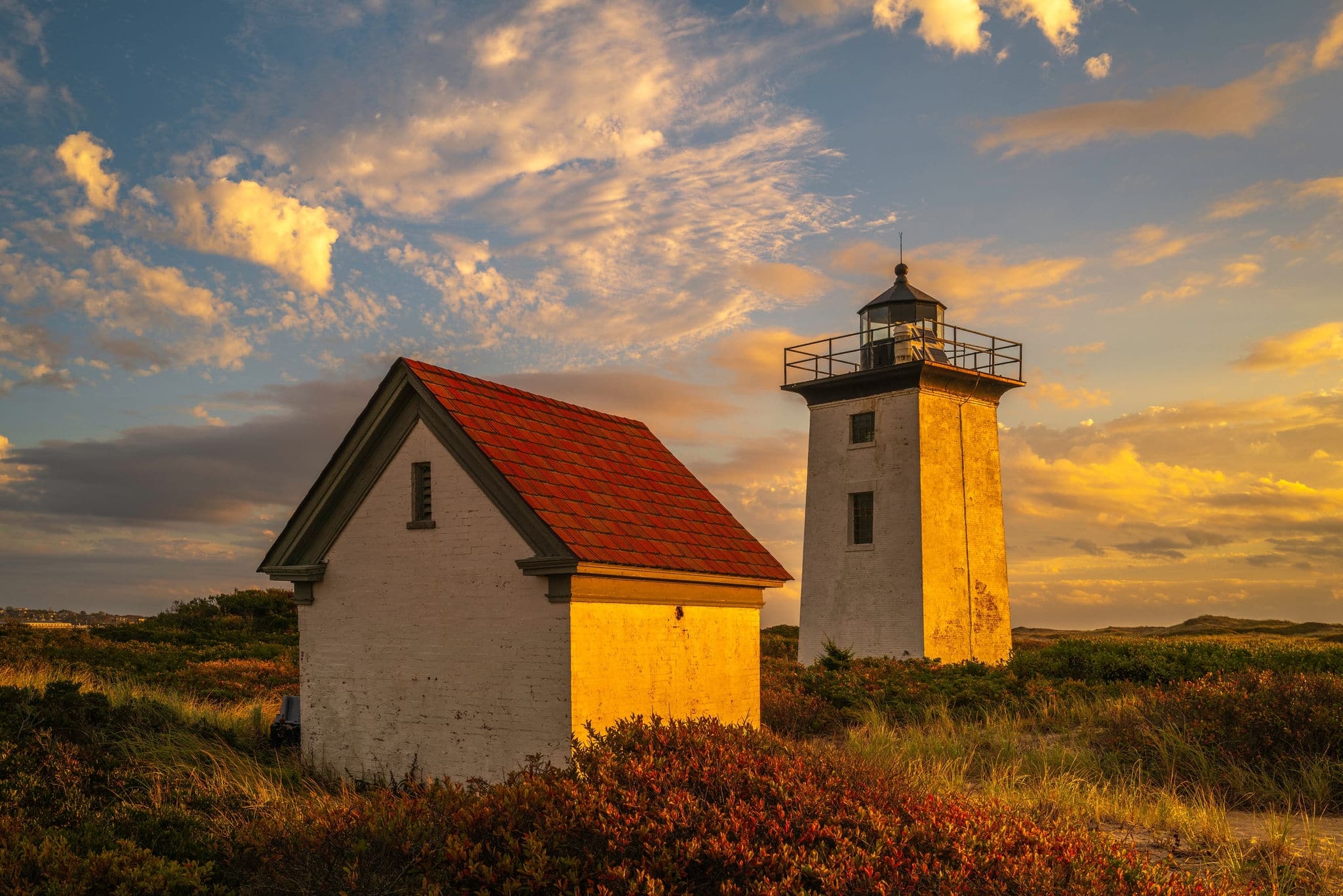 Wood End Lighthouse in Provincetown on Cape Cod, Massachusetts, USA, oceanside beach seascape at golden sunset