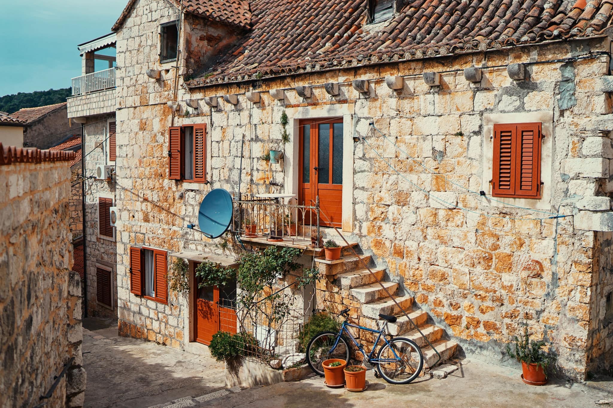 Ancient stone building with tiled roof in Hvar old town, Croatia.