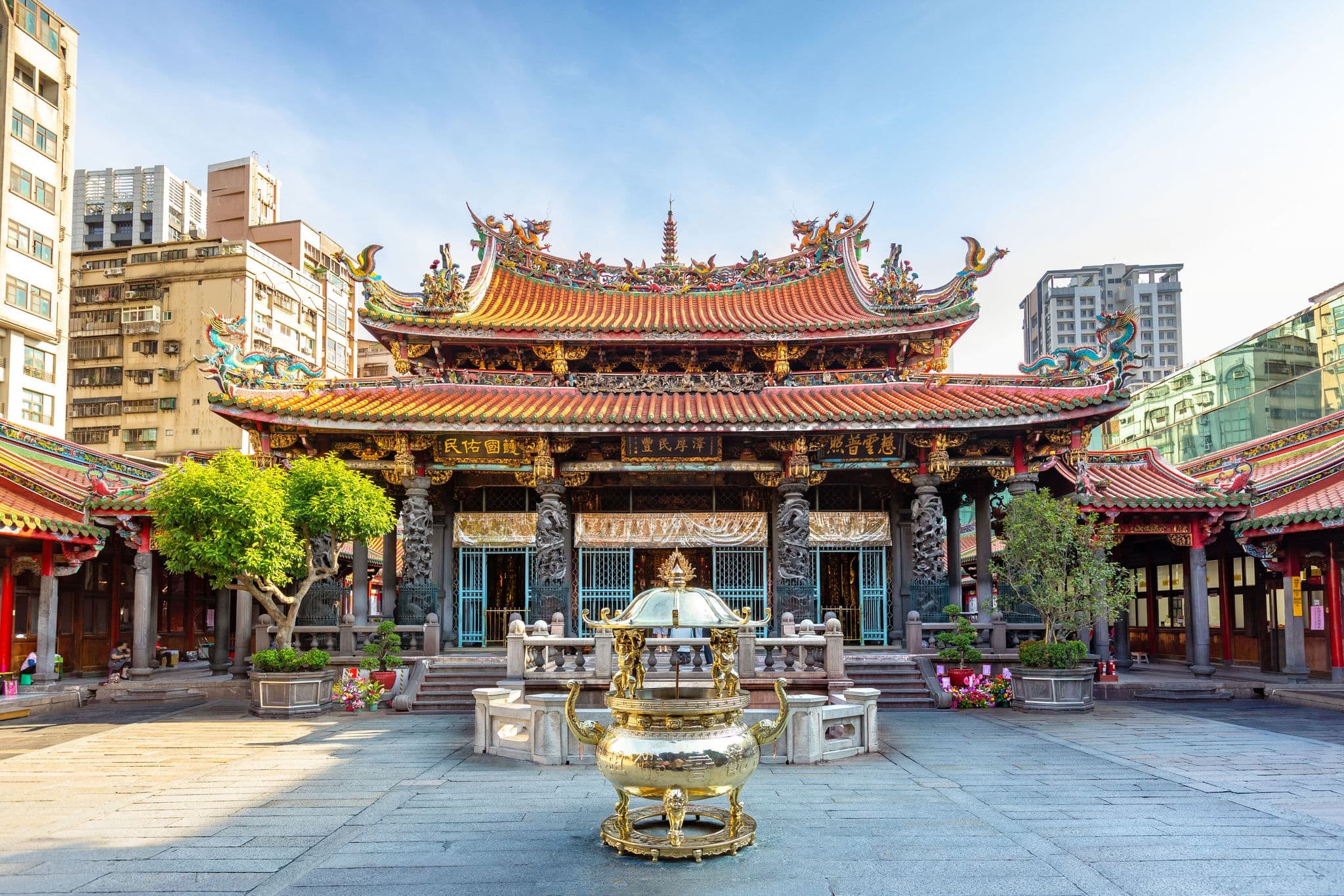 Lungshan Temple in Taipei,Taiwan. The Chinese text is "Protect the people", "Grace and fertility" and "Grace illuminates all creatures". The Chinese text on incense burner is "Guanyin Buddha".
