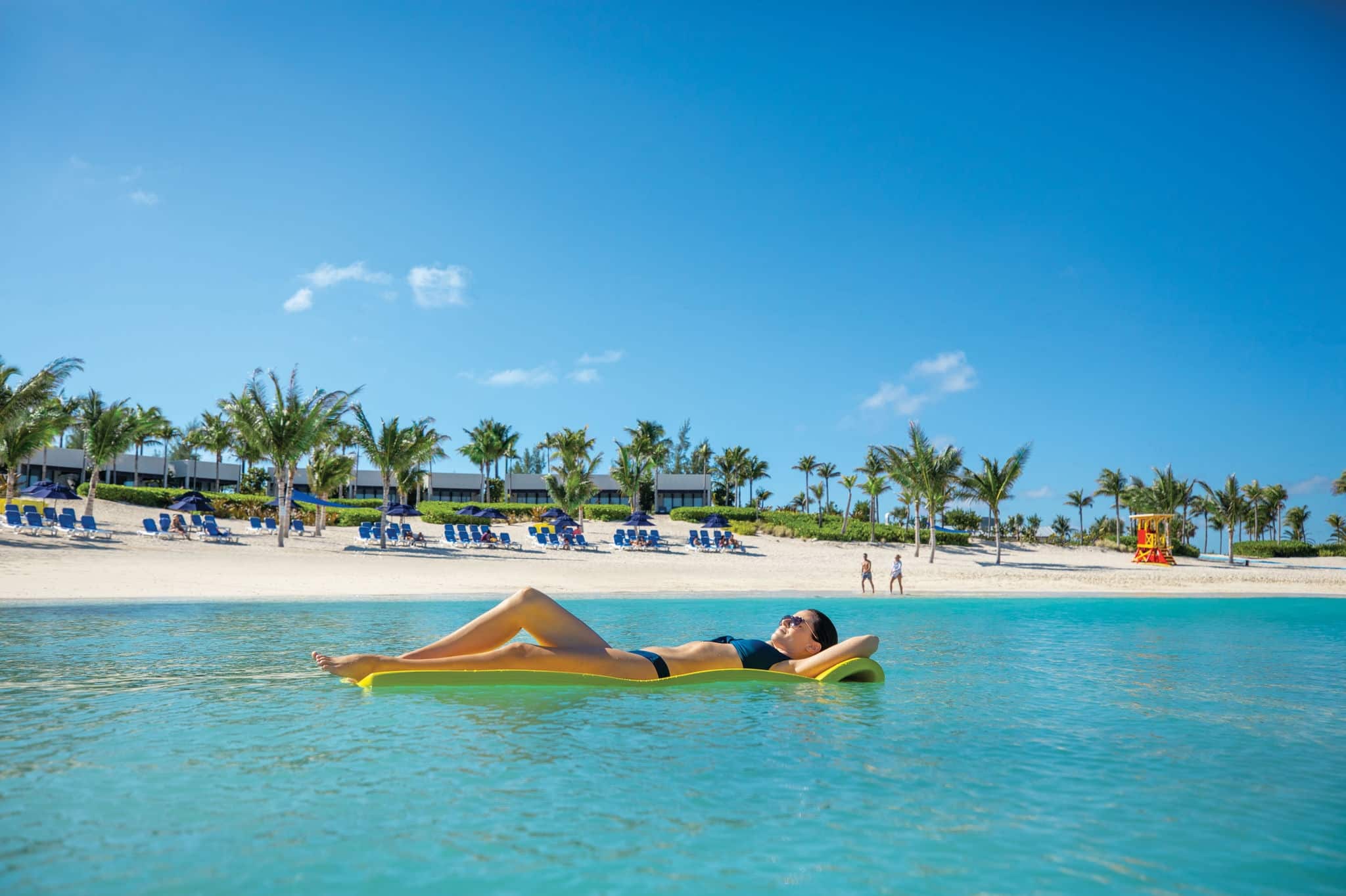 Woman floating in the ocean in Great Stirrup Cay, Bahamas