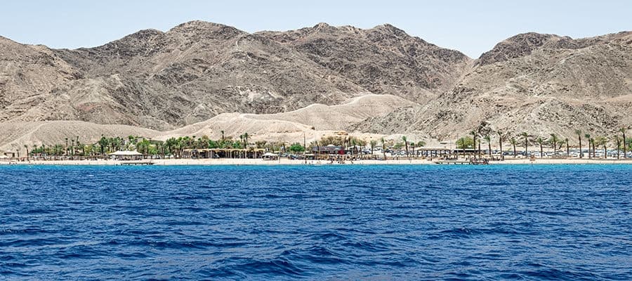 View of Red Sea with rock formations on the distant coast in Sokhna, Egypt. 