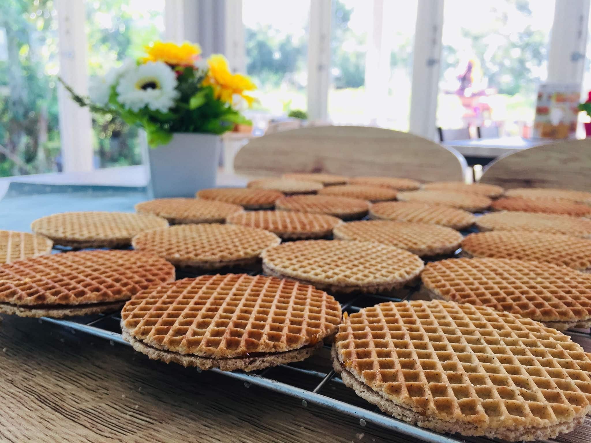 select focus piece of brown homemade stroopwaffel snack on wood table and copy space for text, made from dough and syrup in original taste from dutch