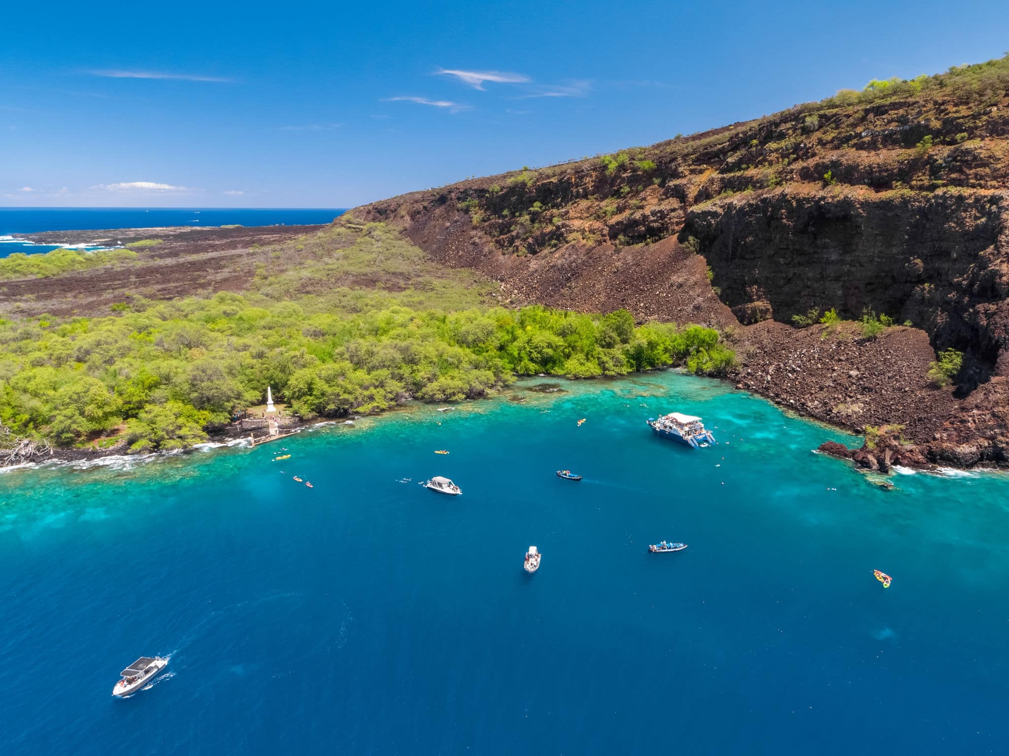 Aerial drone view the Captain James Cook Monument in Kealakekua Bay, Big Island, Hawaii. The monument marks the spot where James Cook was killed in a fight with native Hawaiians in 1779.