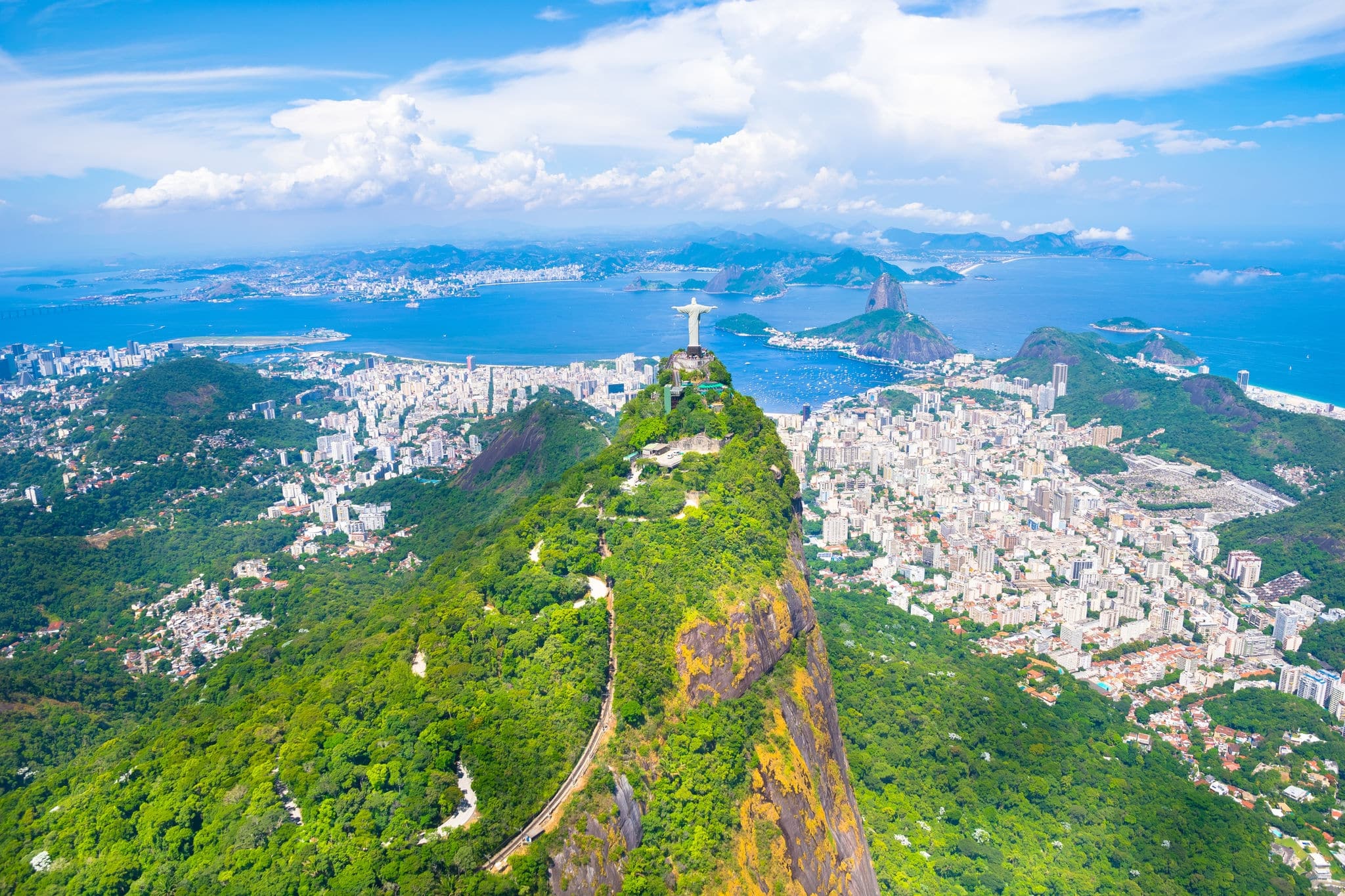 Beautiful aerial view of Rio de Janeiro city with Christ the Redeemer in Corcovado and Sugarloaf Mountain in the background from the helicopter ride - Rio de Janeiro, Brazil