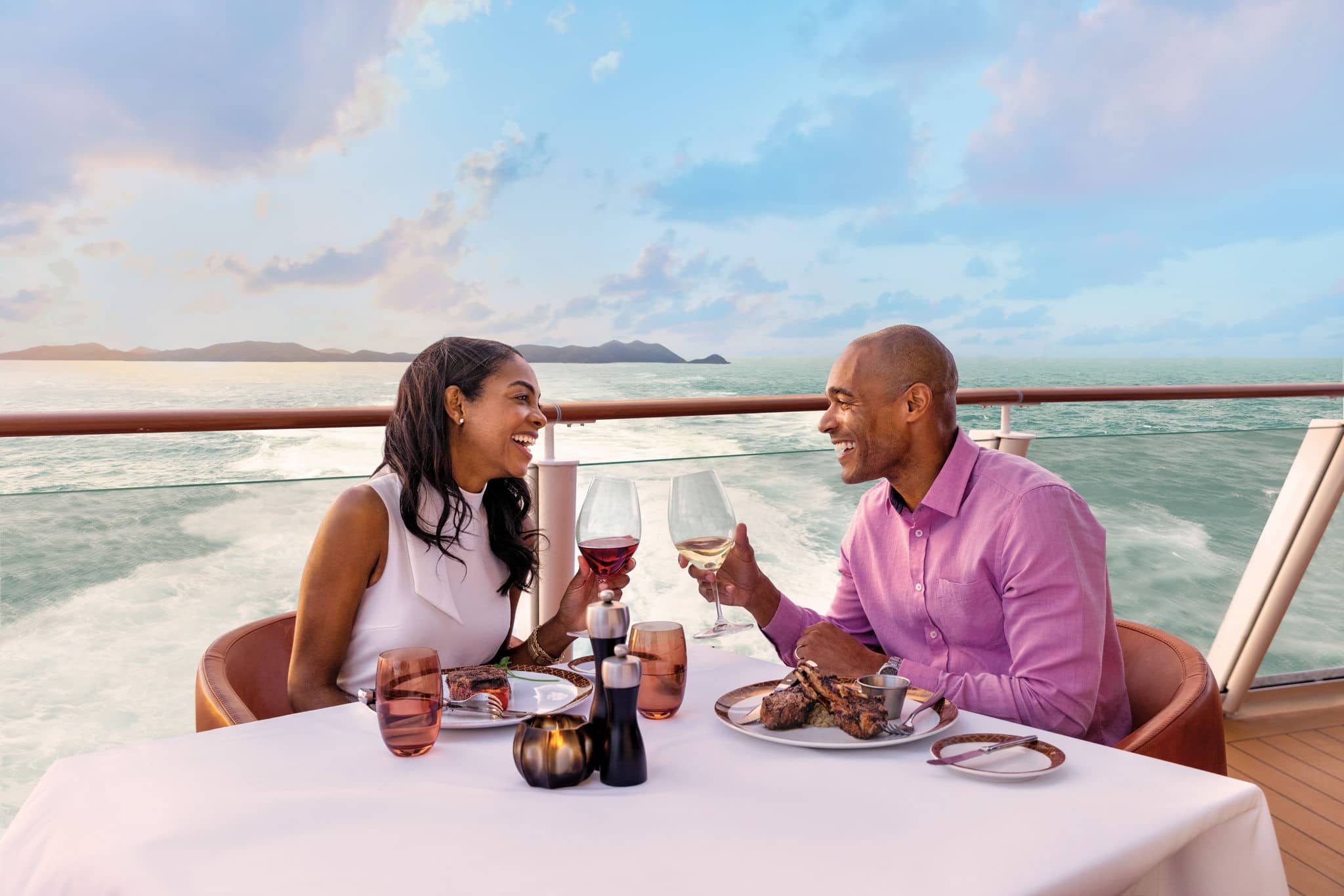 Couple enjoying dining and drinks aboard a Norwegian Cruise Line ship