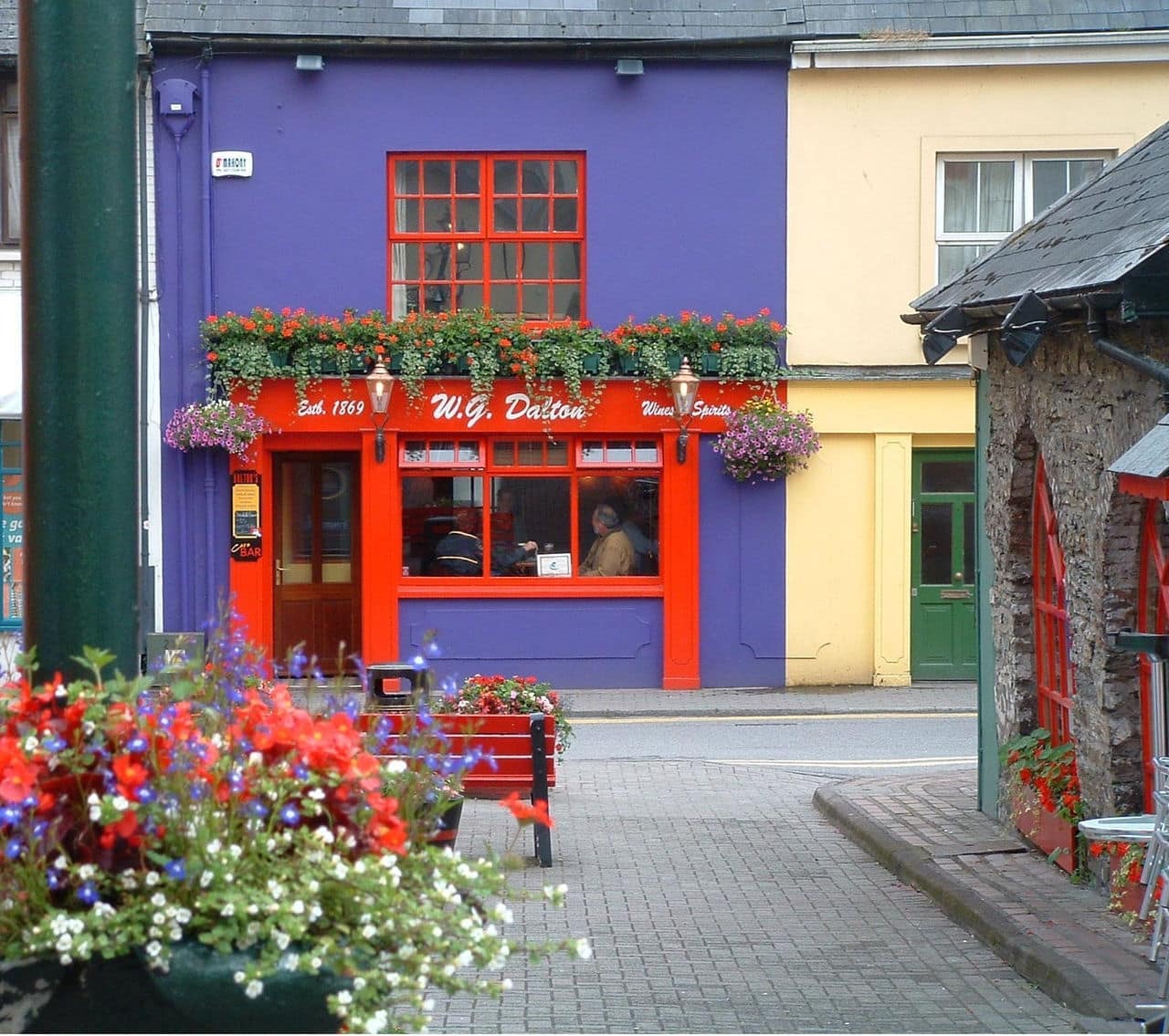 Colorful store front and flowers in quaint Kinsale, Ireland.
