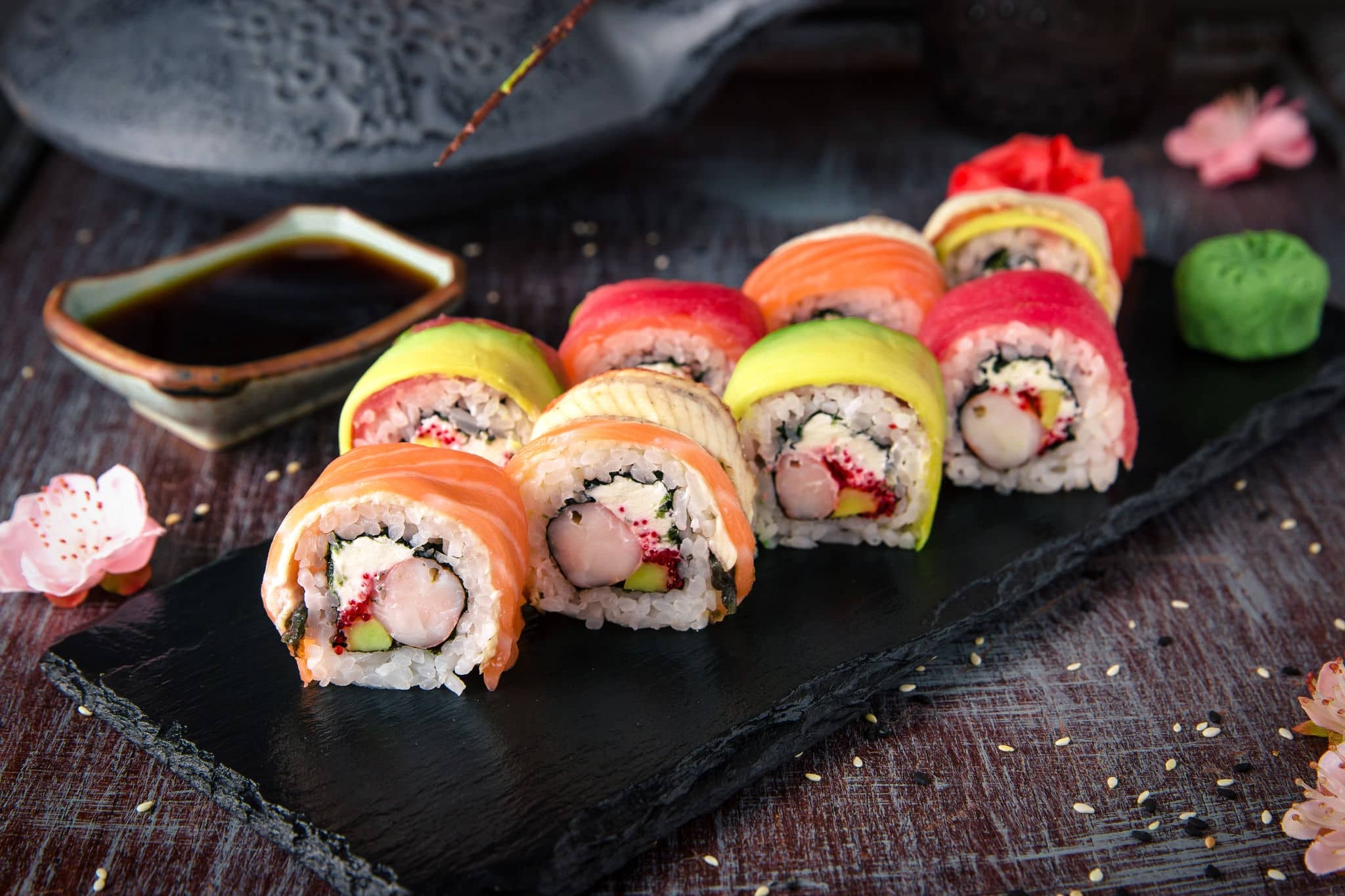 Rainbow Sushi Roll with salmon, eel, tuna, avocado, royal prawn, cream cheese Philadelphia, caviar tobica, chuka. Sushi menu. Japanese food. 