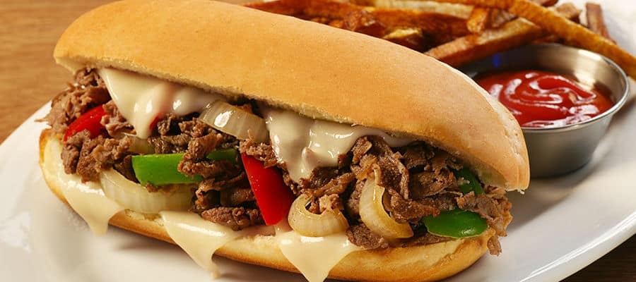 The Philly Cheesesteak is a local favorite sandwich with steak, onions, pepper and cheese on a bun.