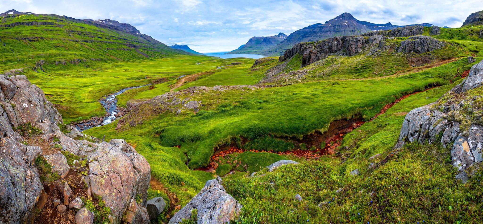 Panoramic view of wilderness of fjord landscape and Selbrekkufoss waterfall near Seydisfjordur on Iceland