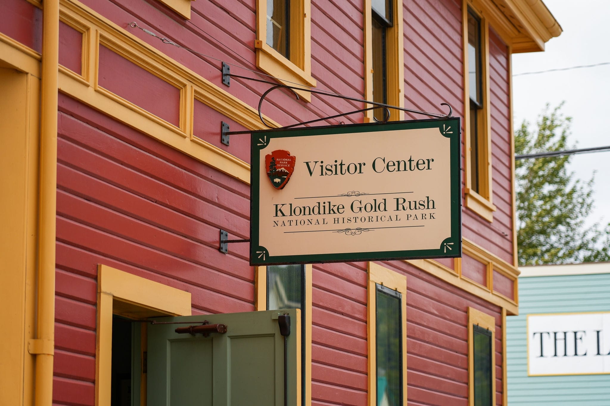 Old city center of Skagway, Alaska - Vintage store signboards on Broadway, the main shopping street of the Klondike Gold Rush National Historic Park