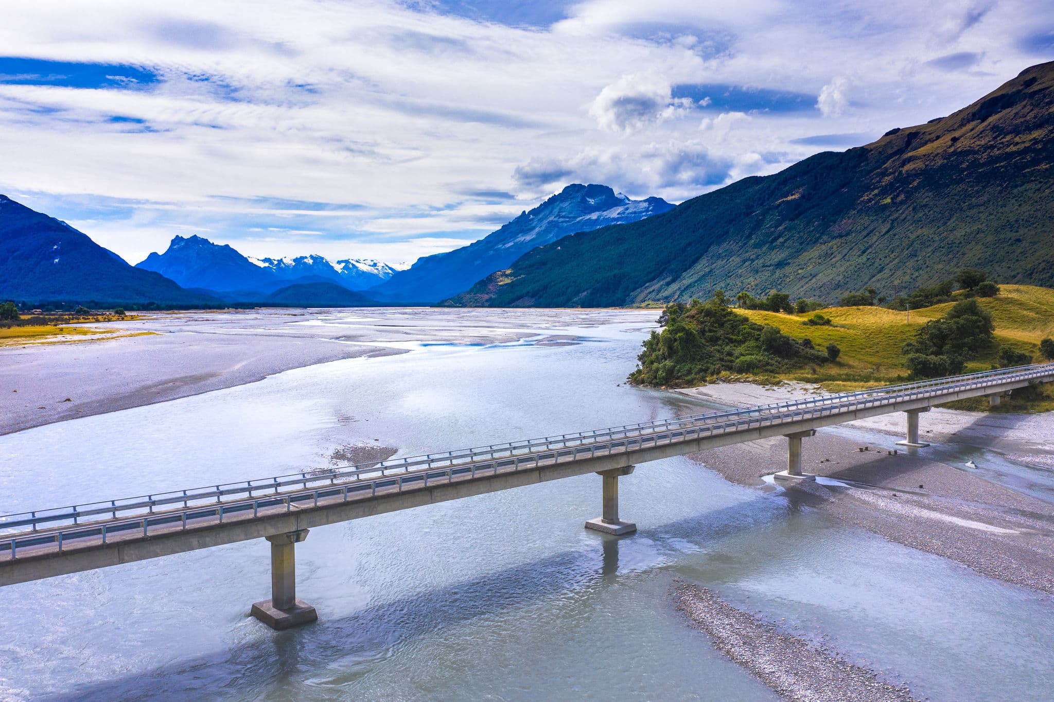 Bridge over the river bank in Glenorchy, scenic Routeburn track popular tourist destination in   Fiordland National Park with a view of Mount Alfred National Park in Glenorchy, Otago, New Zealand