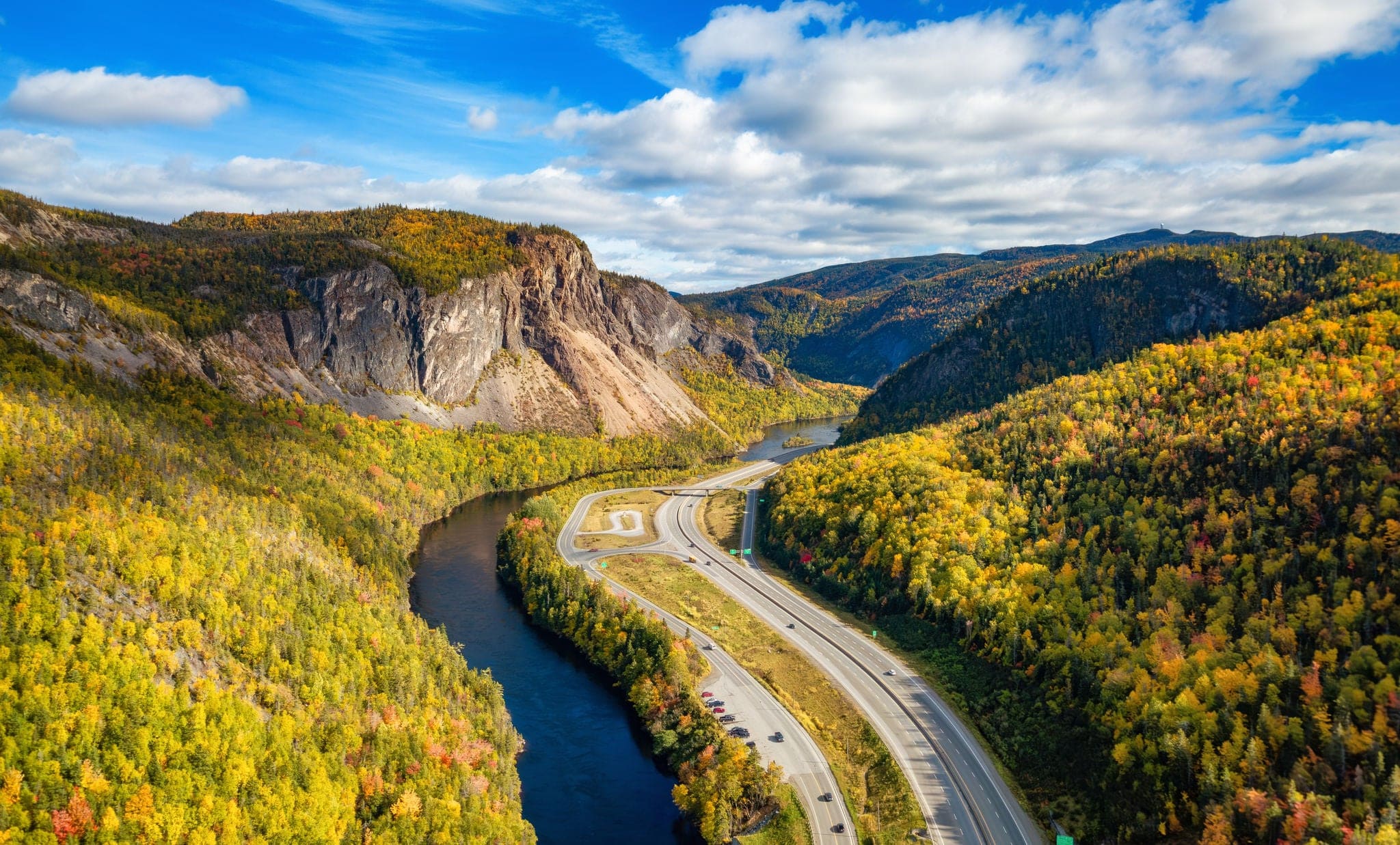 Scenic road in Canadian Mountain Landscape Valley with River. Fall Season. Corner Brook, Newfoundland, Canada.