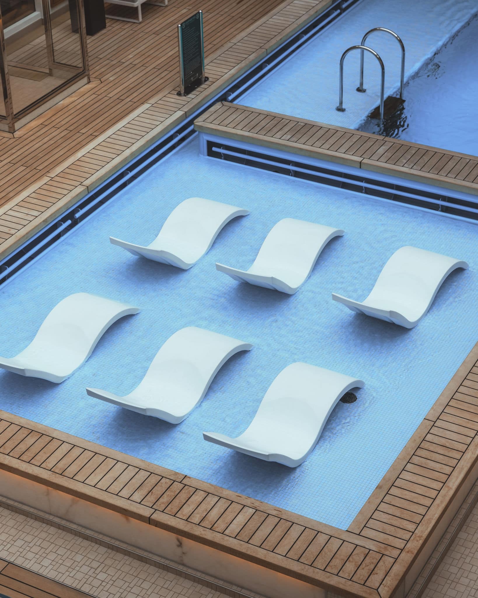 Chairs in the pool on deck. 