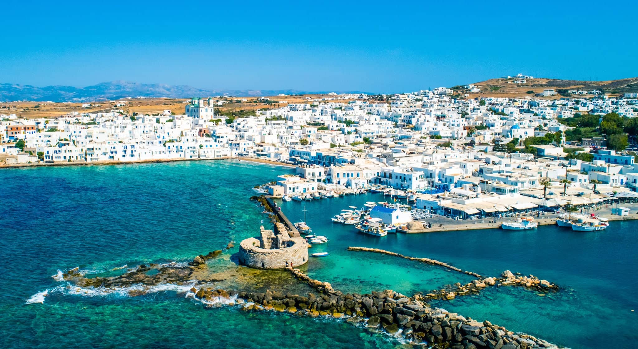 Ancient ruins of Venetian castle in the harbor of Naoussa town, view from above, Paros island, Greece