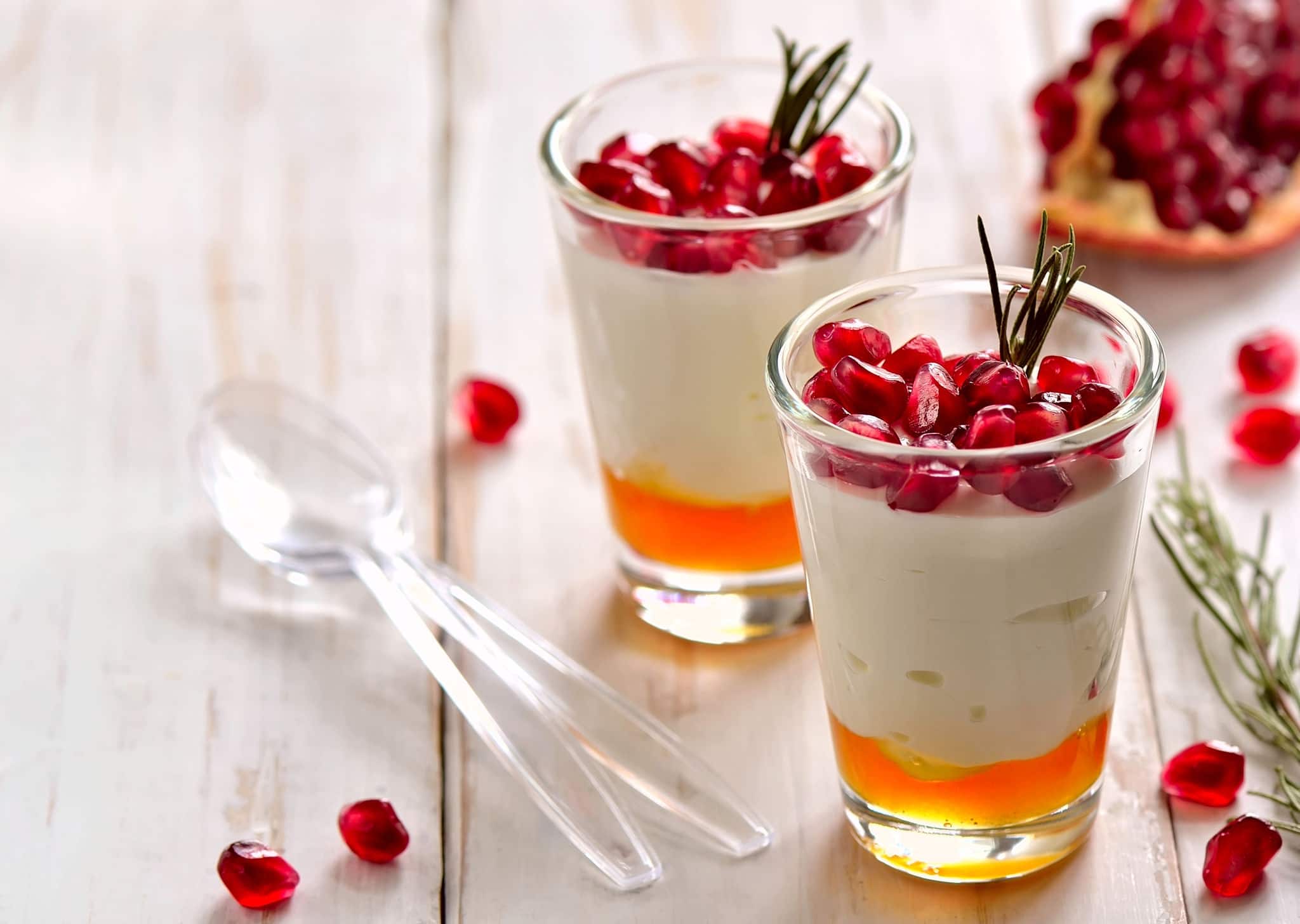 Pafait or yogurt with honey and juicy pomegranate seeds decorated with rosemary