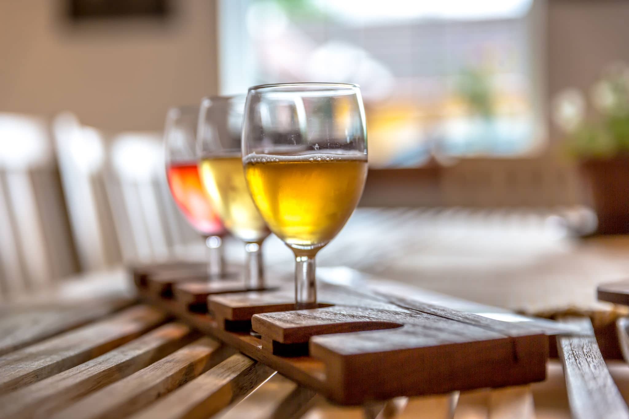 Three glasses of Cider in a wood table in Norway