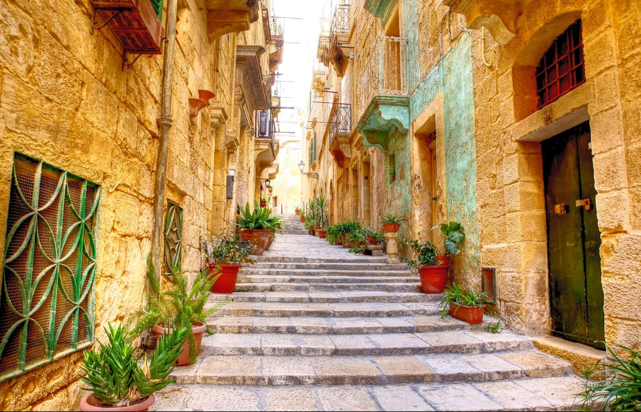 typical narrow street with stairs in the city Valetta on the island of Malta