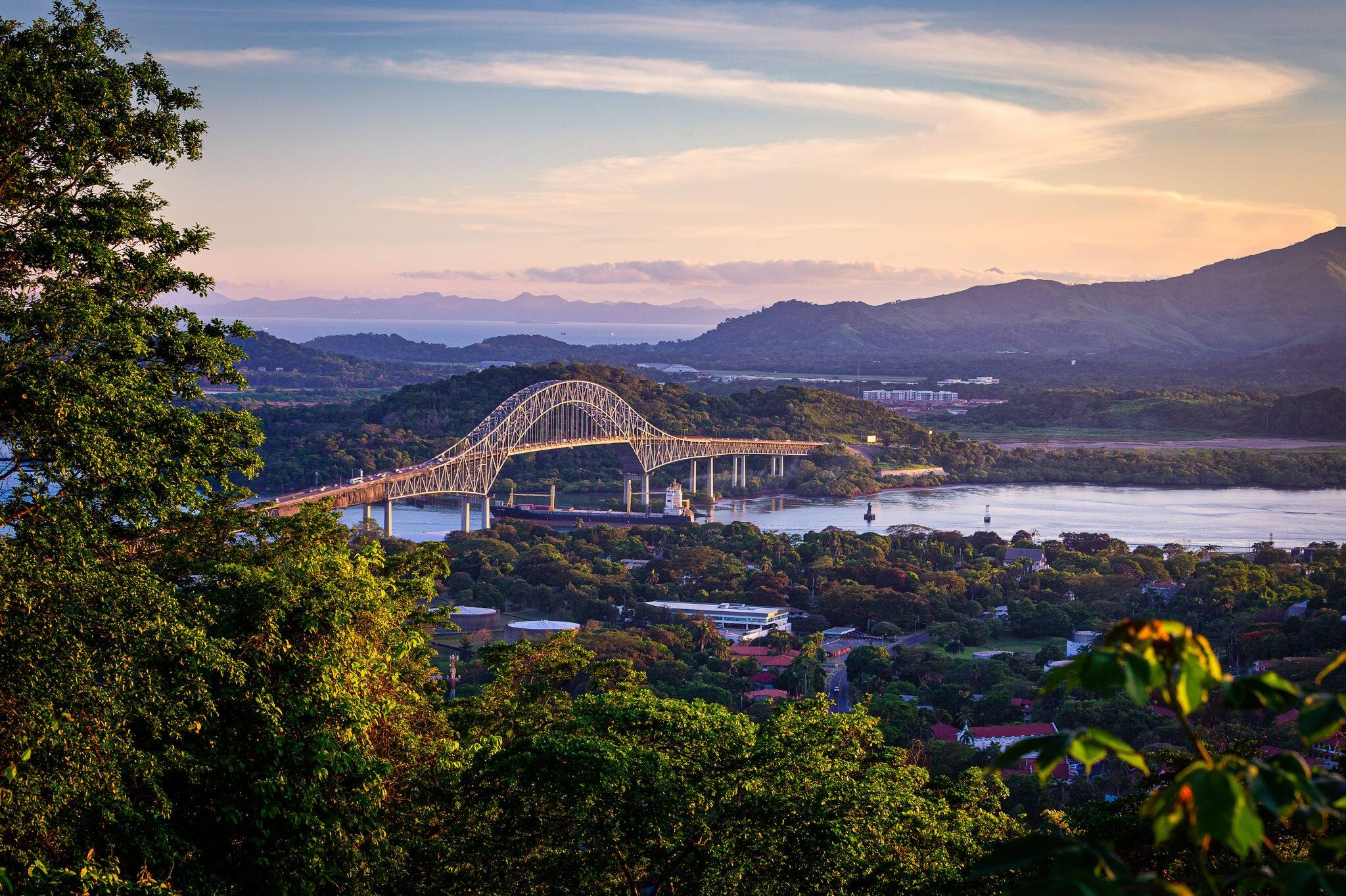 Container ship passing througha in scenic landscape