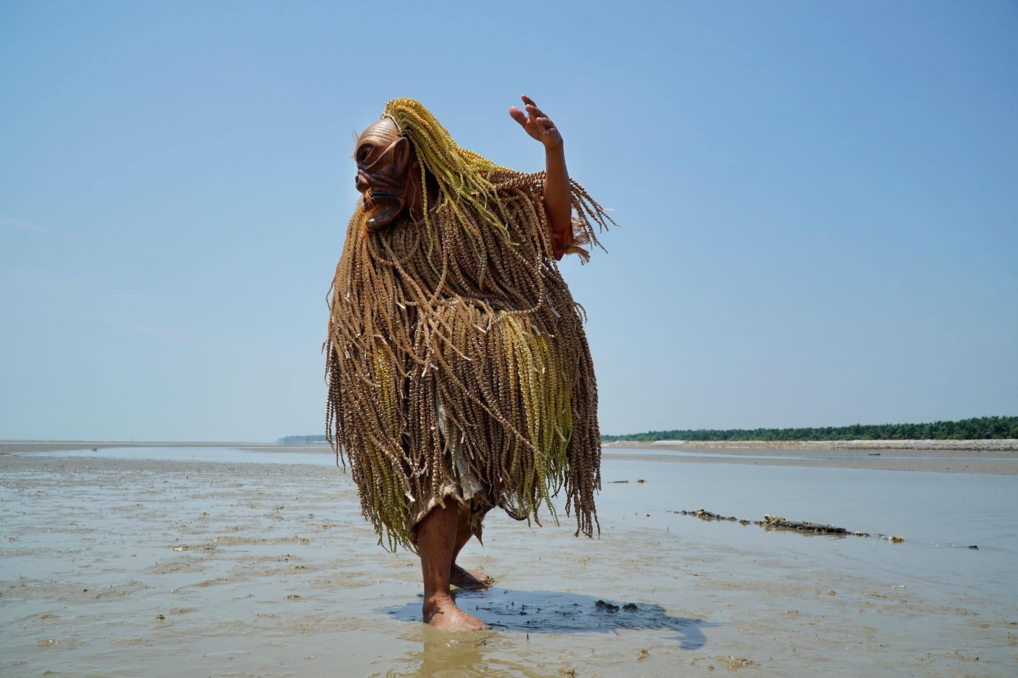 An unidentified man wearing a wooden mask for the Mahyin Jo-oh dance during the annual Puja Pantai (Ocean Healing) rituals.