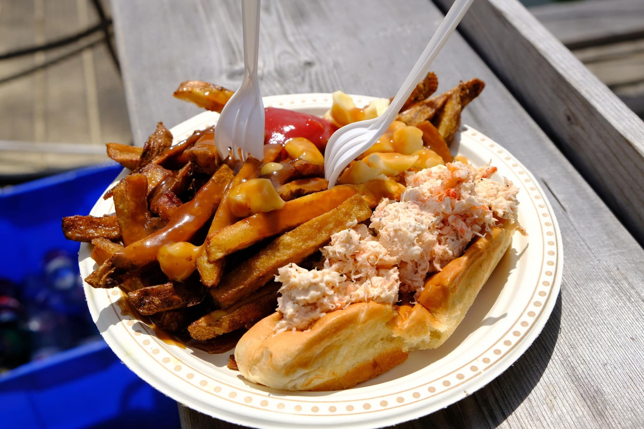Poutine and Lobster rolls combo on a sunny day outdoors