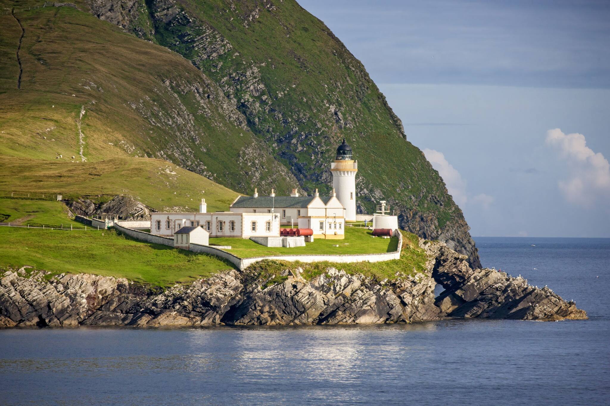 Beautiful lighthouse and buildings on the island of Bressay in the Shetland Islands in Scotland.