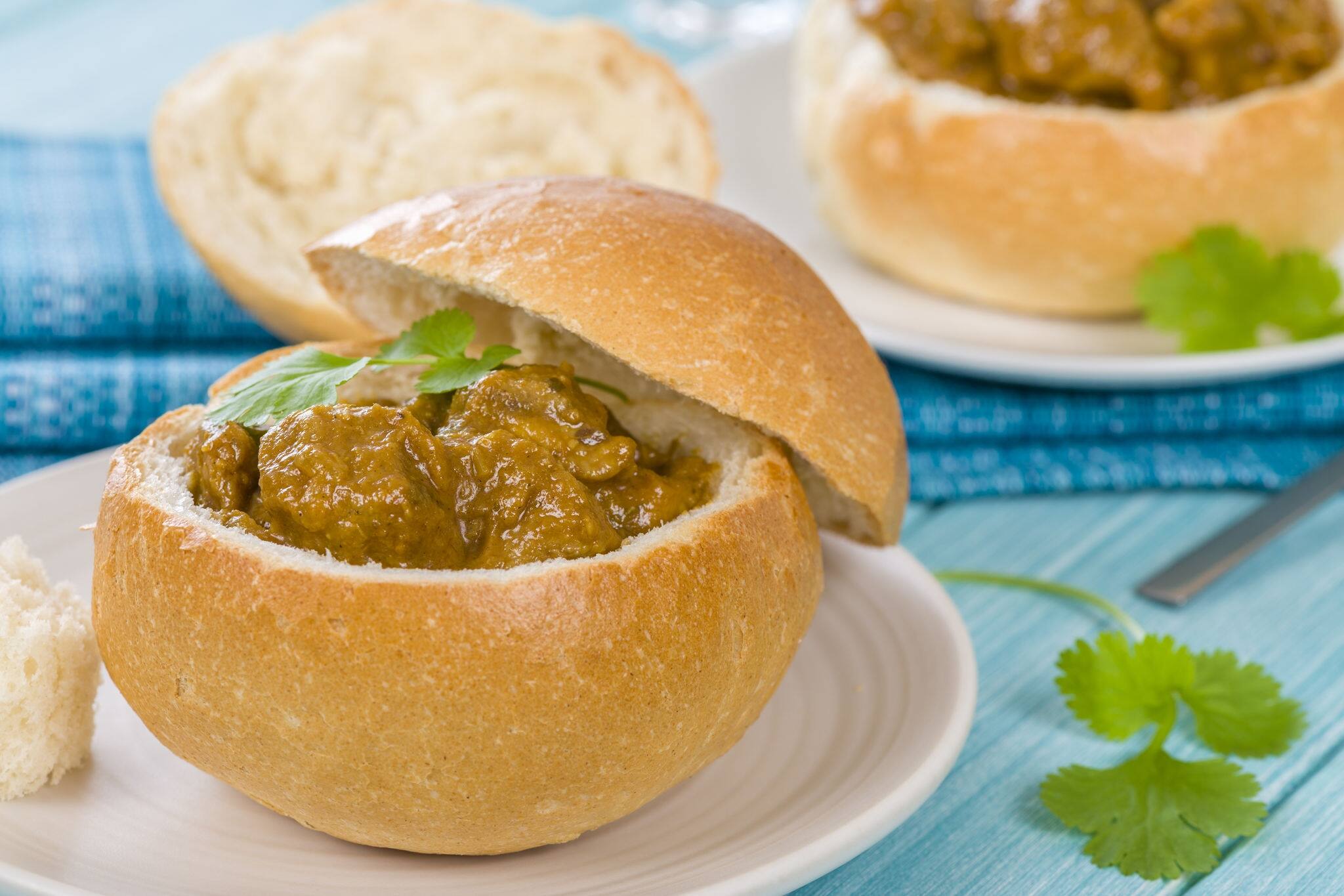 Bunny Chow - South African mutton curry served inside a hollow bread bun.