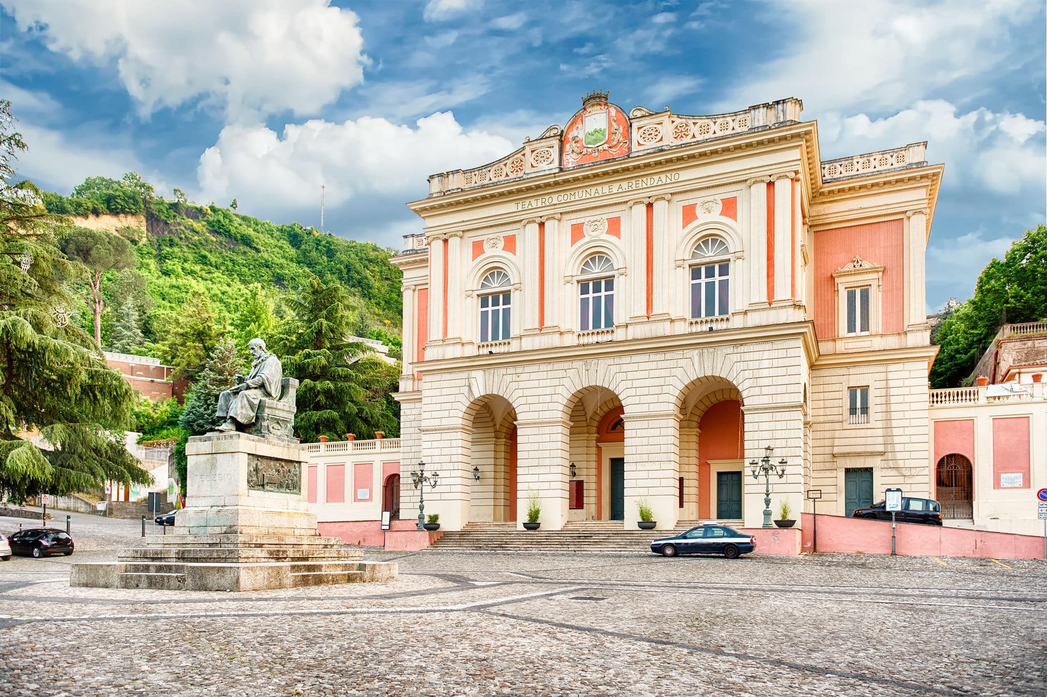 The iconic 25th March square with statue of Bernardino Telesio and Rendano Theatre in the background. Old town of Cosenza, Italy